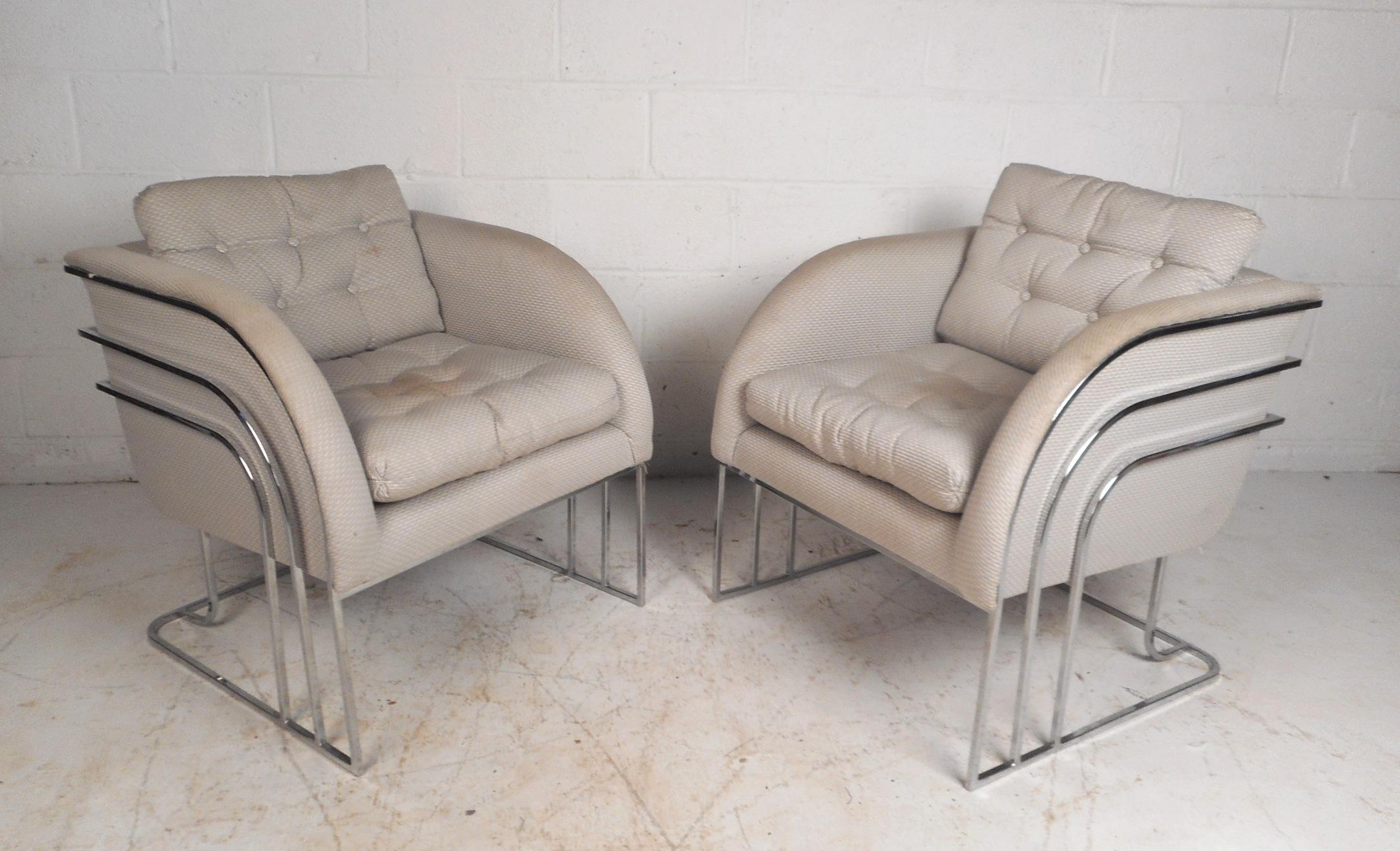 This beautiful pair of vintage modern lounge chairs feature an Art Deco style curved chrome frame. Sleek and comfortable design with rounded arm rests and thick padded removable cushions. This fabulous pair of Milo Baughman chairs makes the perfect