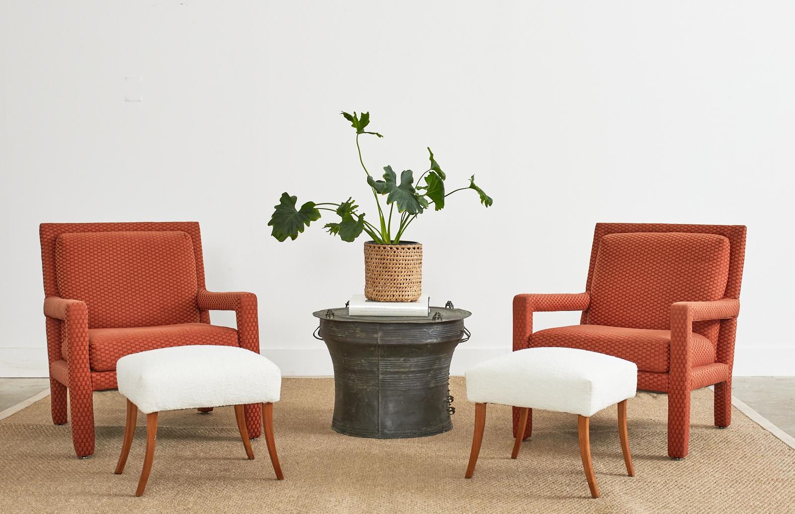 Fabulous pair of mid-century modern parsons chairs or armchairs made in the manner and style of Milo Baughman. The iconic chairs feature a strong wooden frame with large open arms and a slanted flat back. The back and seat have a thick pillow