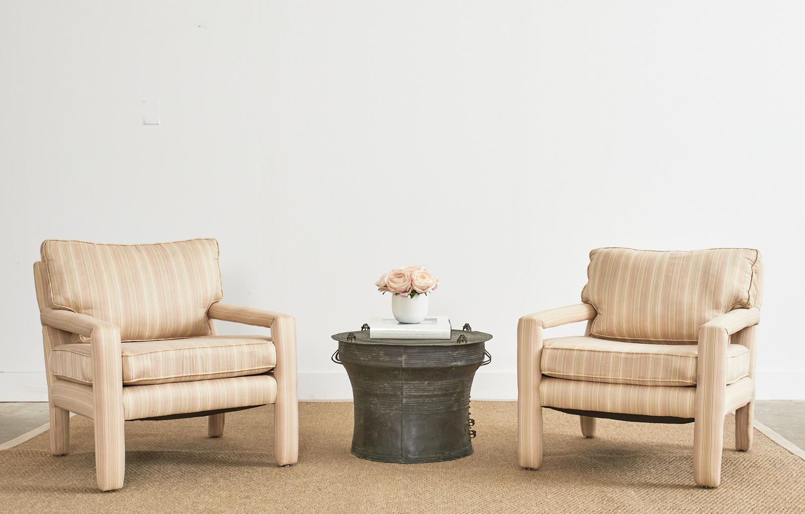 Exquisite pair of Mid-Century Modern Parsons chairs made in the manner and style of Milo Baughman. The iconic chairs feature a modern redux with shimmery geometric pattern fabric. The fabric has colors of white, beige, and pink in a delicate striped