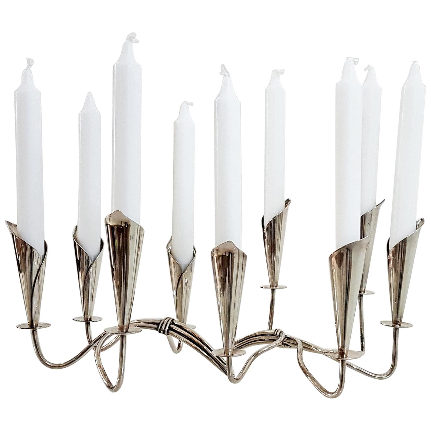 A pair of Hans Jensen calla lily design candle holders with room for four and five candles respectively in silver plate. Each is stamped Danmark, the swimming Whale makers mark. The design is effectful in it's simplicity with tapering lilies and