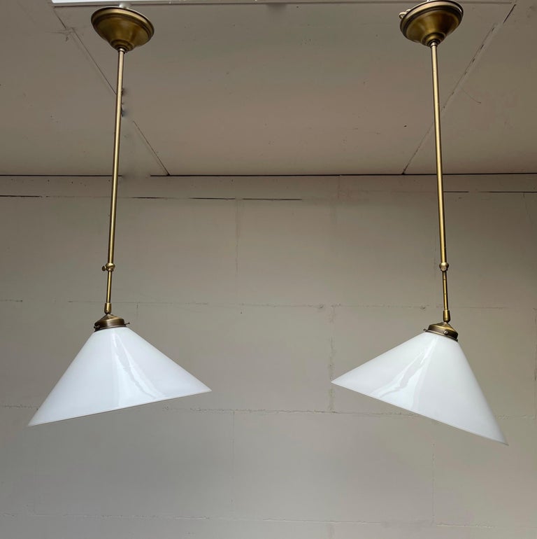 Perfect size and shape, adjustable pendants from the midcentury design era.

These very stylish 1970s light fixtures come with the original brass canopies and shade holders intact. They are in very good to excellent condition and the combination of