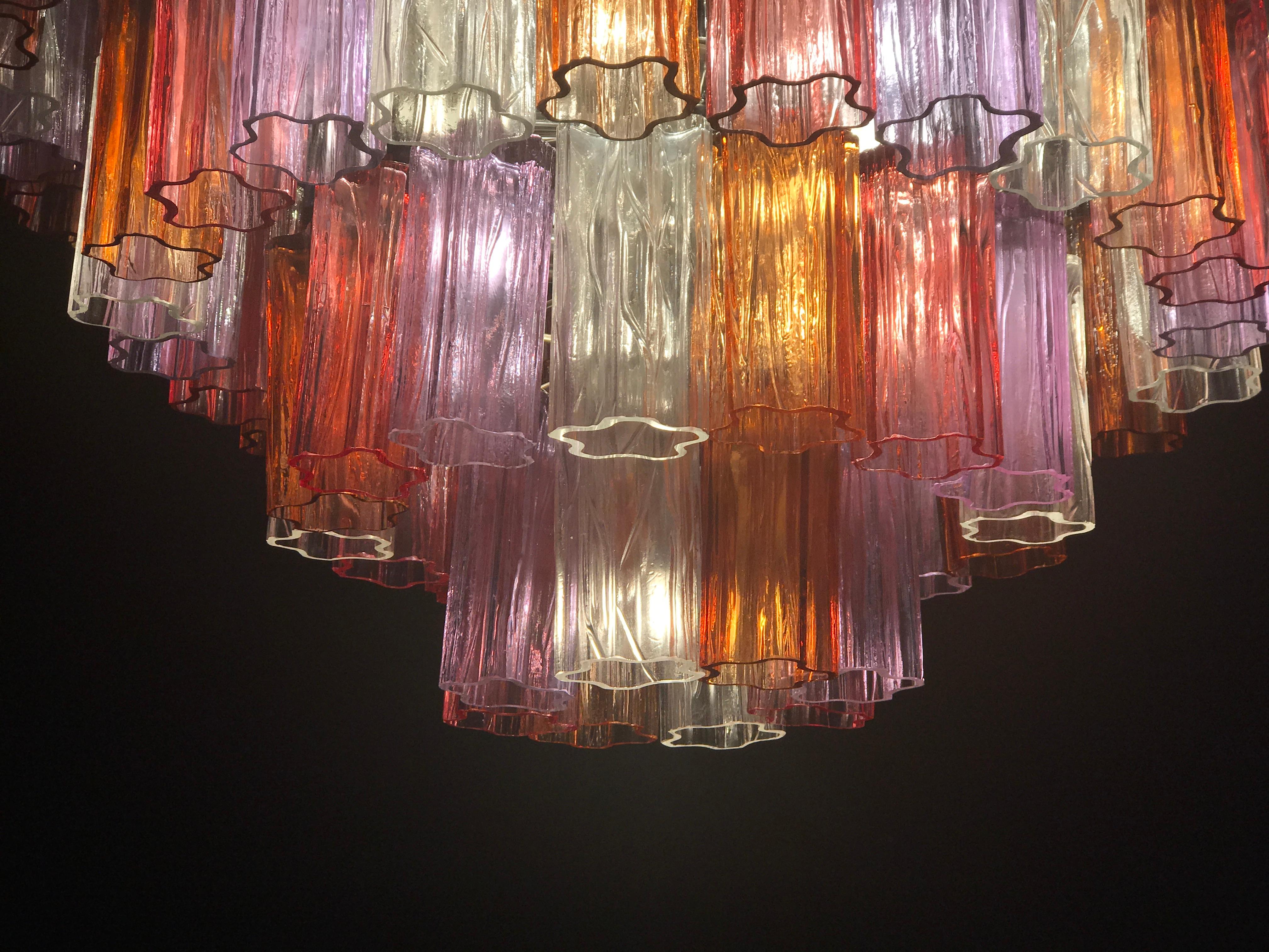 This amazing pair of chandelier with rare color combination considering the uniqueness with amber, pink, amethyst, and ice color precious Murano glasses. Each chandelier with 80 glass blown elements supported by a chrome frame.
12 E 14 light bulbs.