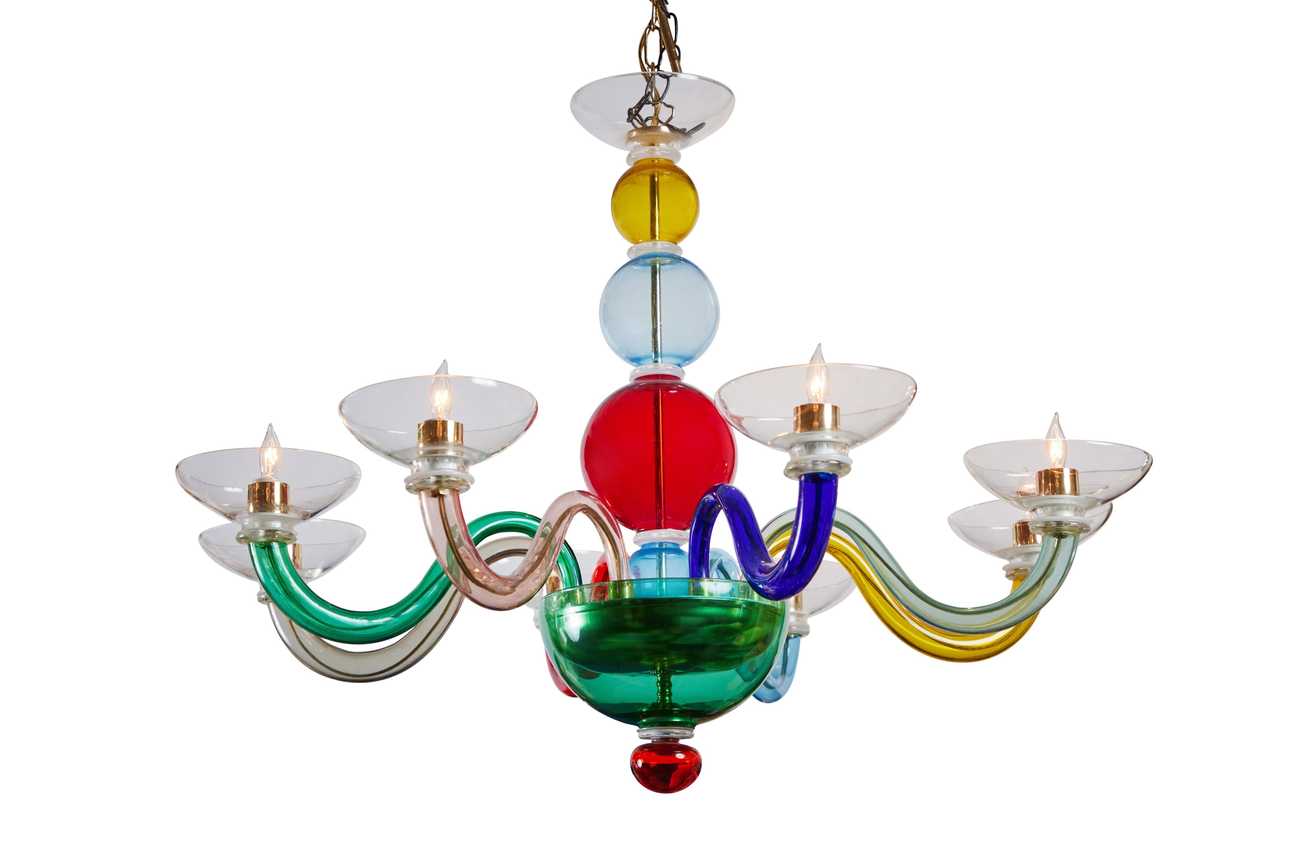 Wonderful pair of multicolored, Murano chandeliers from Italy. Each with a center column of spheres terminating in an emerald colored dish, branching out to eight, serpentine arms. Wired for U.S. current.  Note:  one without gold metal plate above