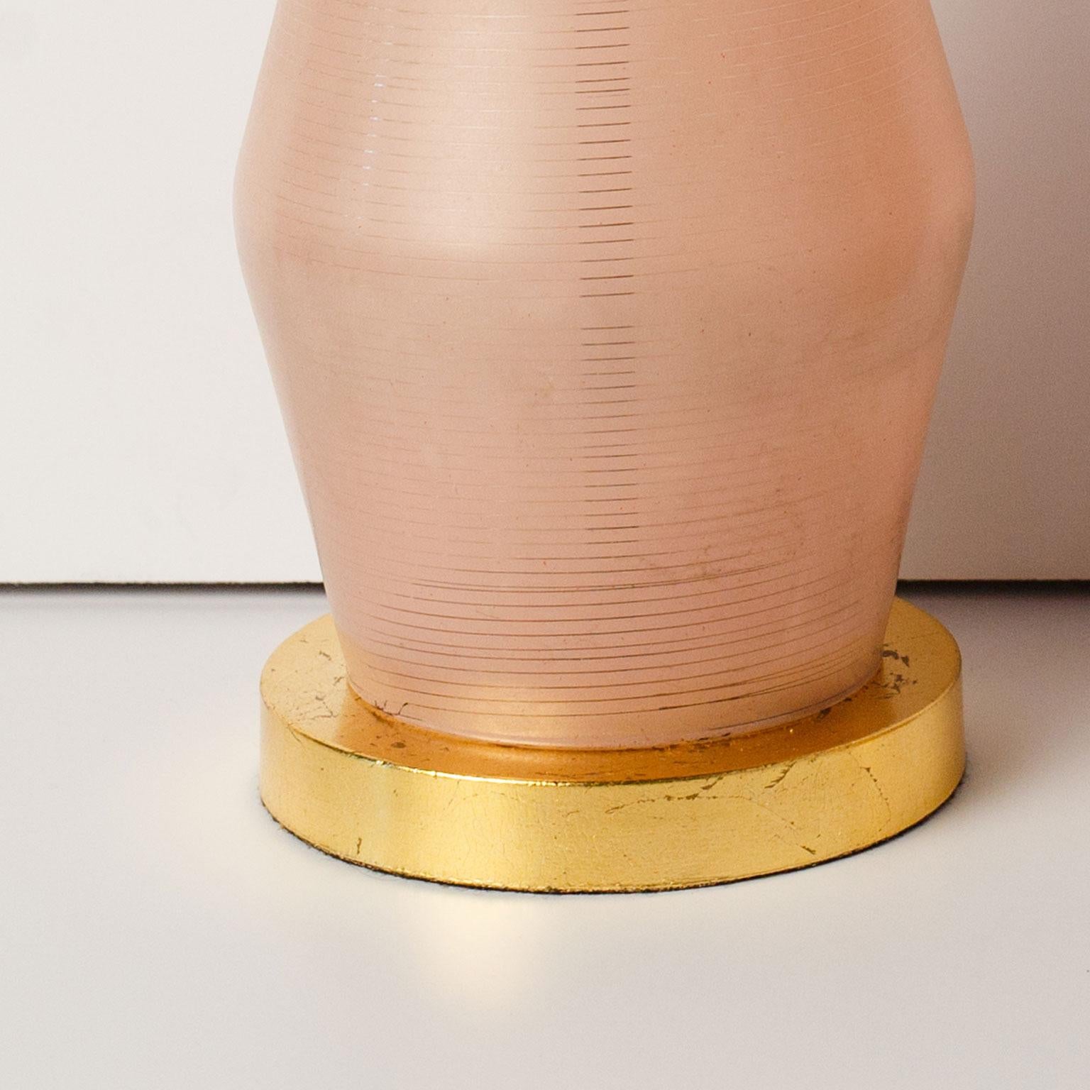 Pair of midcentury Murano lamps. Hand blown semi-opaque pinkish-champagne glass table lamps on gilt-brass bases. Newly wired for use within the USA. Sold as a pair without shades. Sold as a pair. The 16 inch measurement is to the top of the socket.
 