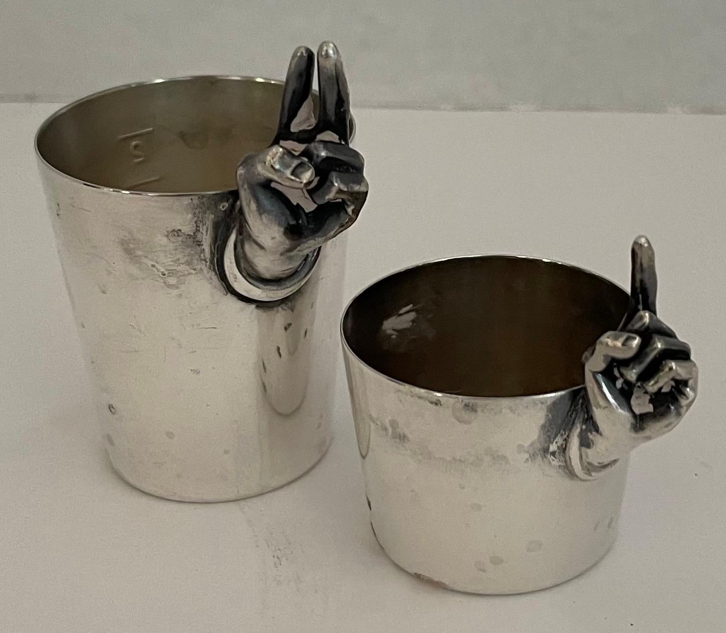 Pair of midcentury silver plated finger jiggers by Napier. Larger is 2.25” tall x 2” diameter. 1.25”tall x 1.75” wide.