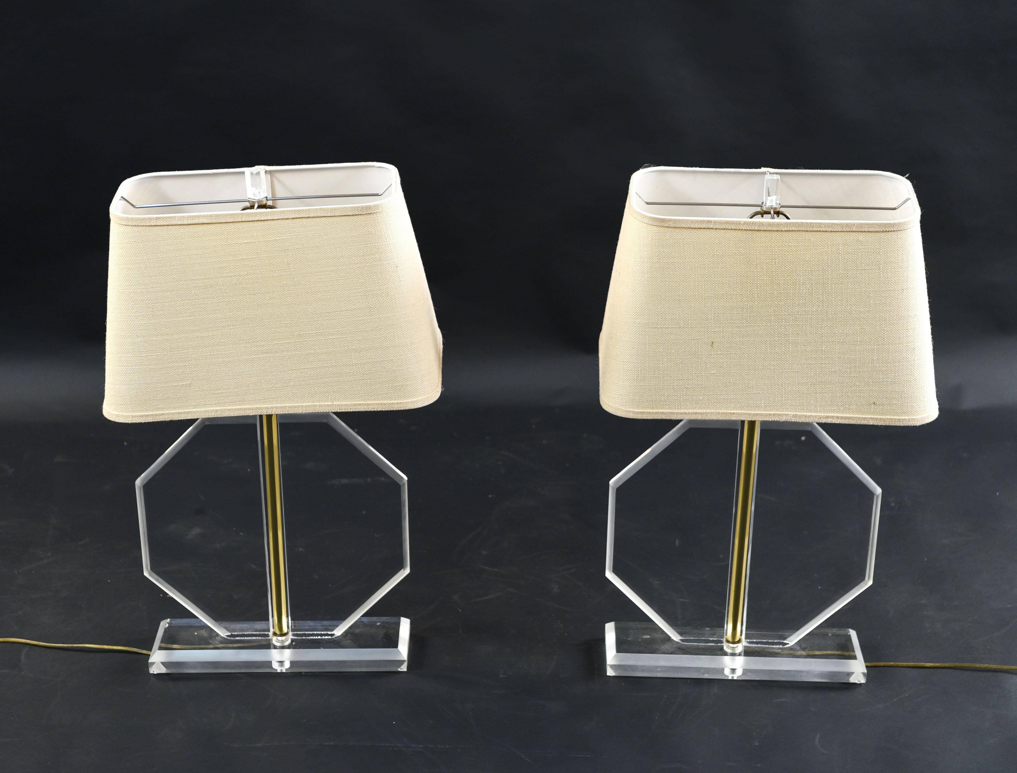 These midcentury Lucite table lamps are of an octagonal form. Due to their thin shape, they would work well on either side of a console, or in another narrow space.
