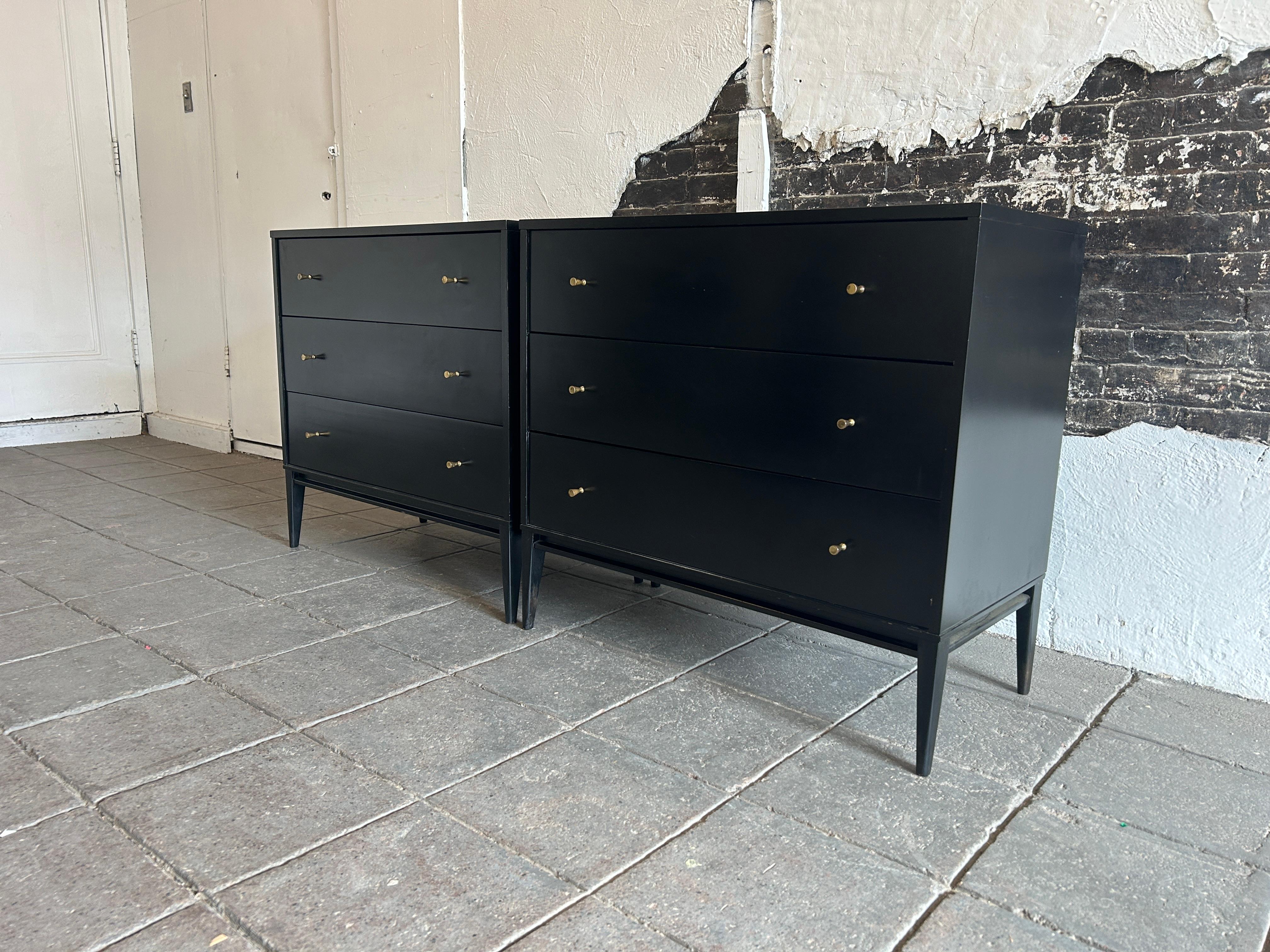 Pair of Mid-Century Modern black lacquer three-drawer dresser by Paul McCobb for Winchendon Furniture Company. Part of the Planner Group. Labeled. Beautiful original black lacquer with original brass knobs with patina. Located in NYC.

This