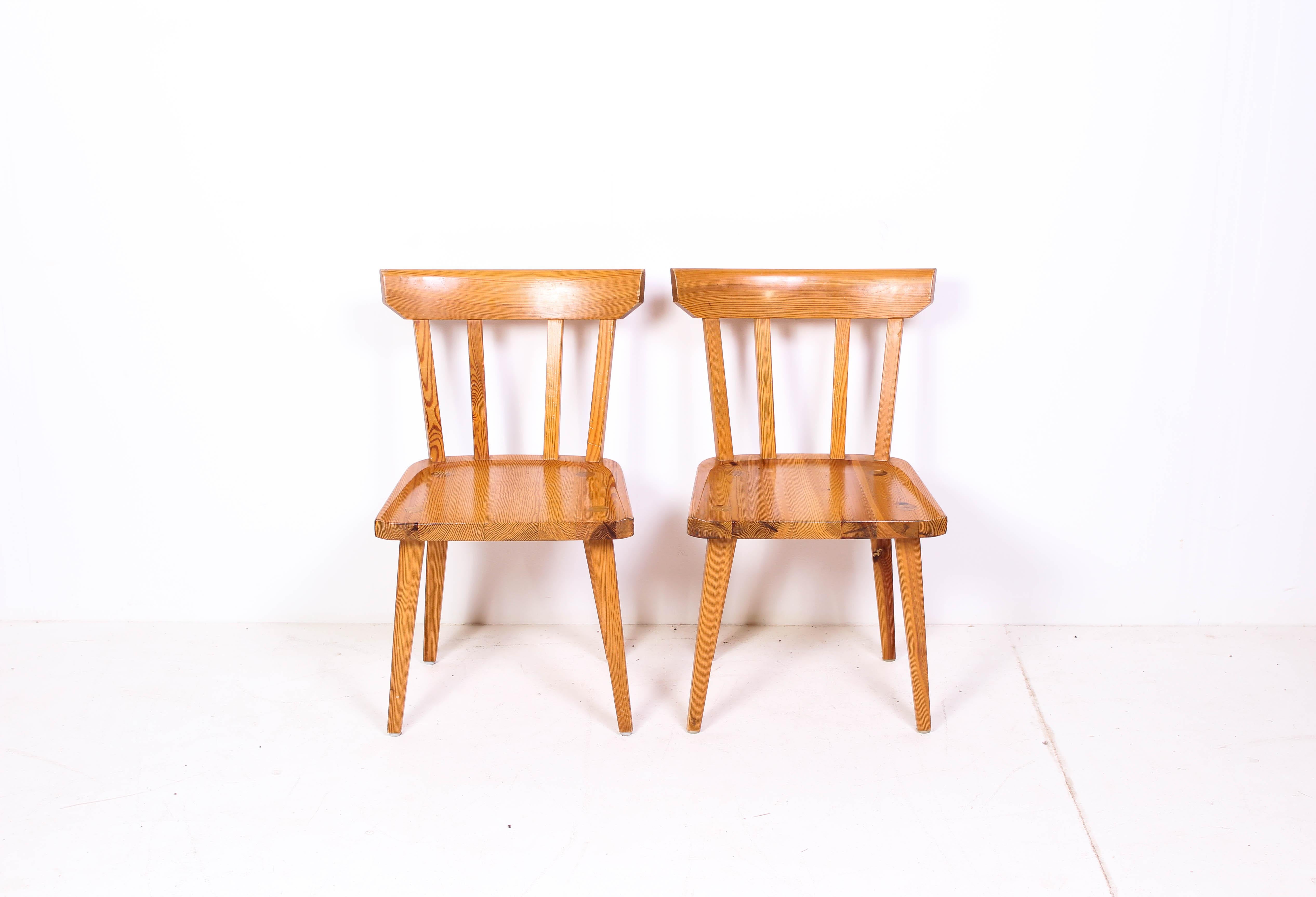 A pair of midcentury pine dining chairs by Karl Andersson & Söner from the 1960s. The design is by Carl Malmsten. Great craftsmanship. Very good vintage condition with signs of usage consistent with age.
