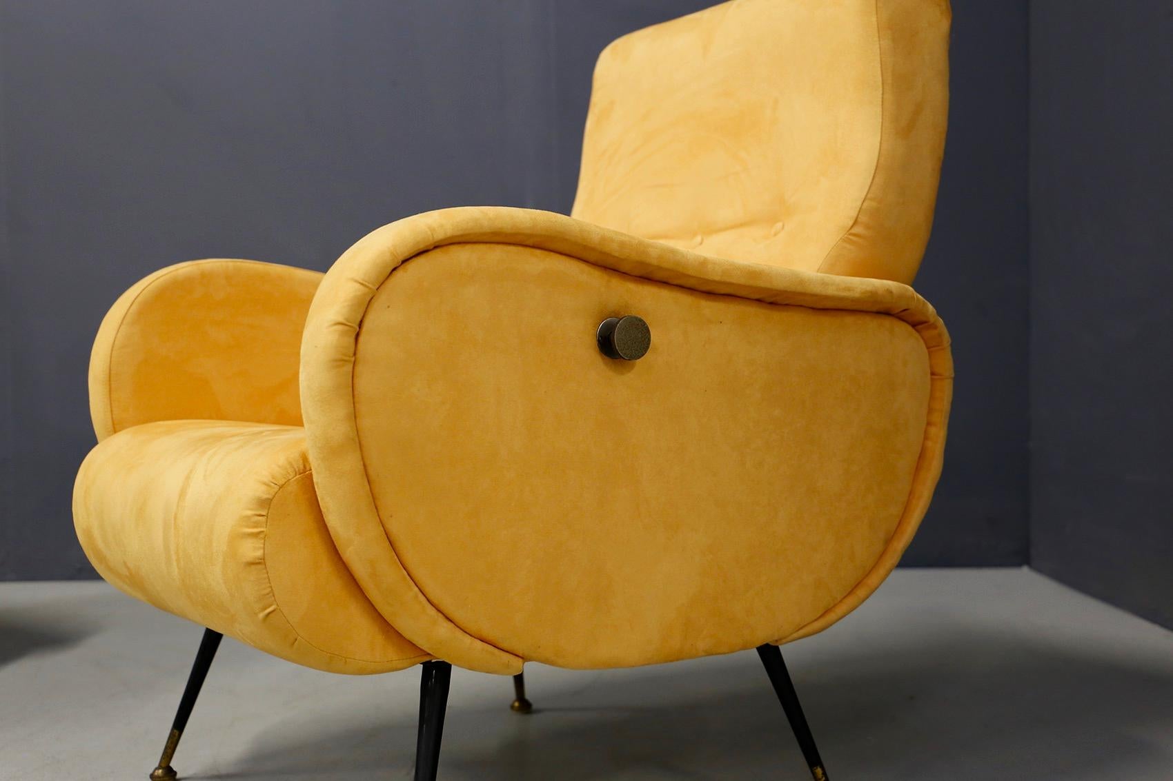 Pair of restored midcentury Italian armchairs from 1950. The armchairs are lined in yellow velvet. The particularity of the seats is their mechanism that makes the armchair reclining. Its mechanism is operated by a brass knob positioned on the sides