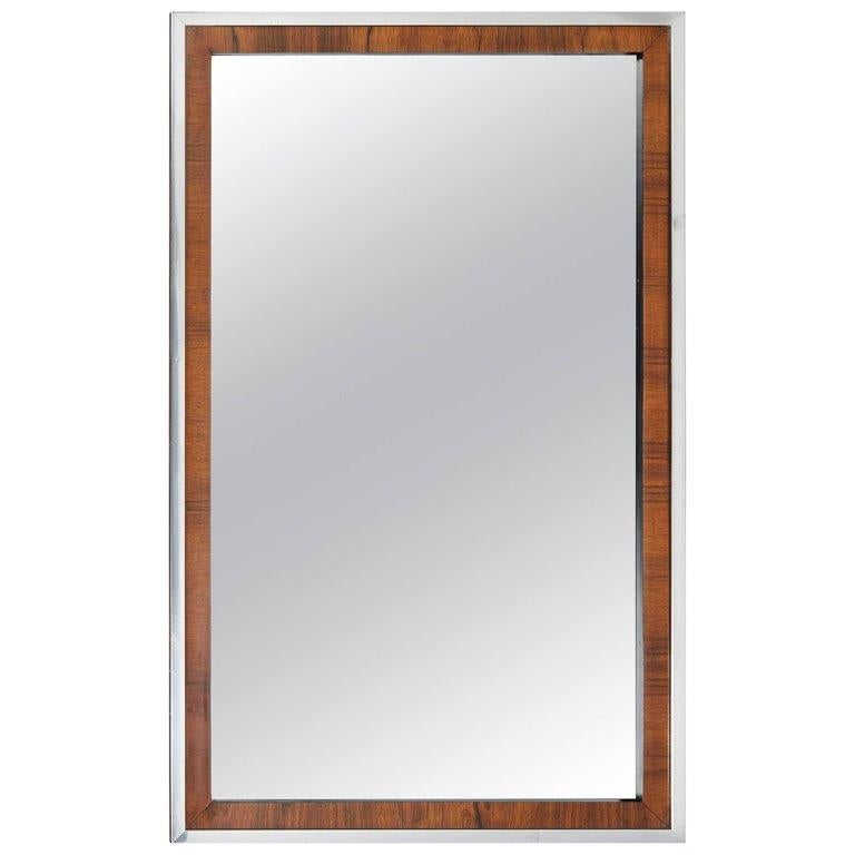 A clean, sleek and sophisticated Modernist mirror in rosewood with full chrome surround on all four sides of frame, with a black side surround.
Milo Baughman for John Stuart
Can be hung horizontally or vertically.
Original glass inset in fine
