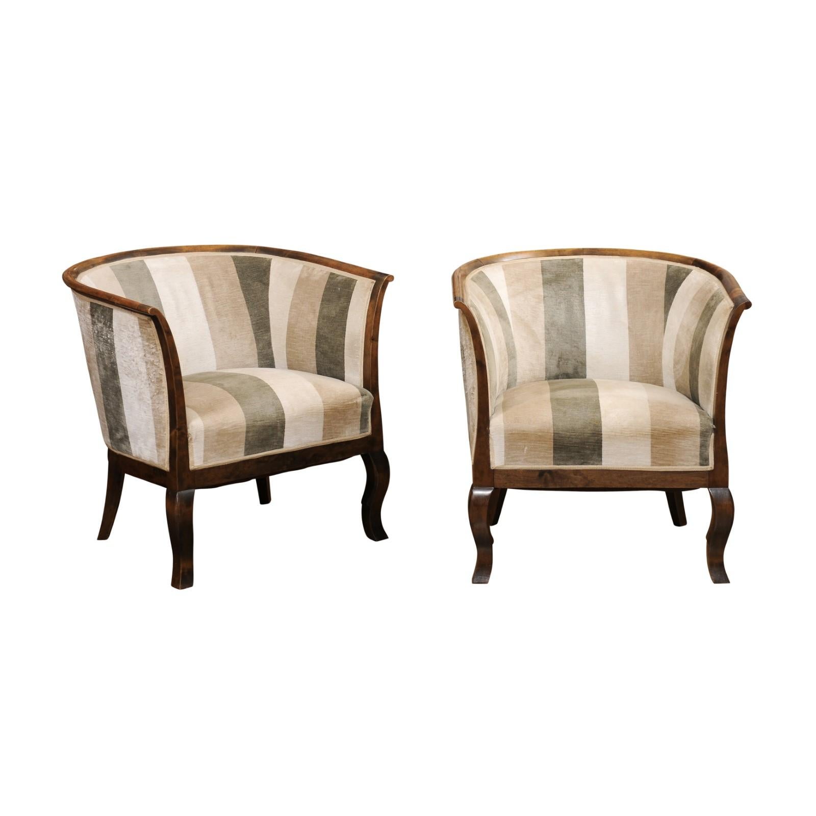 A pair of Scandinavian Midcentury birch wood club armchairs circa 1950 with horseshoe backs. Discover the quintessential blend of form and function with this pair of Scandinavian Midcentury birch wood club armchairs, circa 1950, a duo that embodies