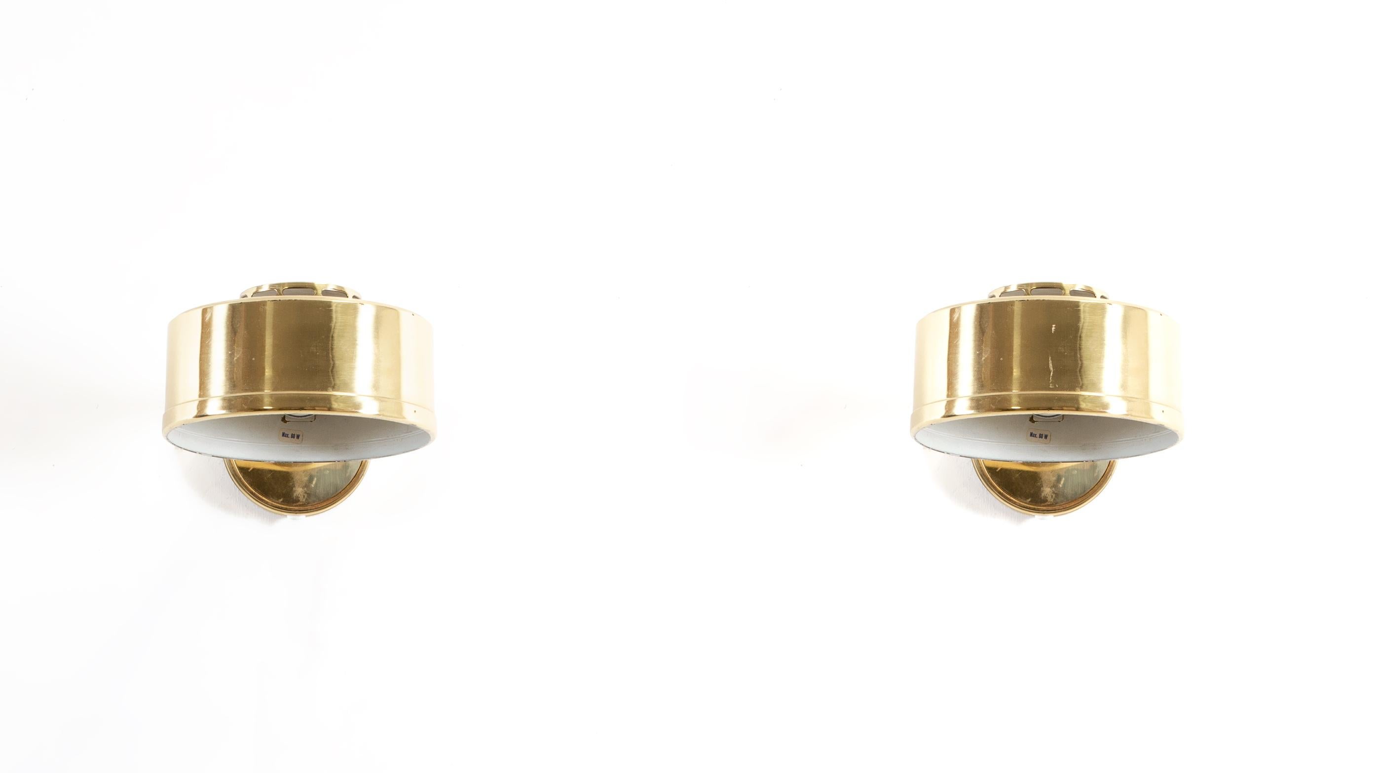 Sublime pair of wall lights in brass. Designed and made in Sweden from circa 1970s first half. Both lamps are in good vintage condition and fully working. Max 60W.