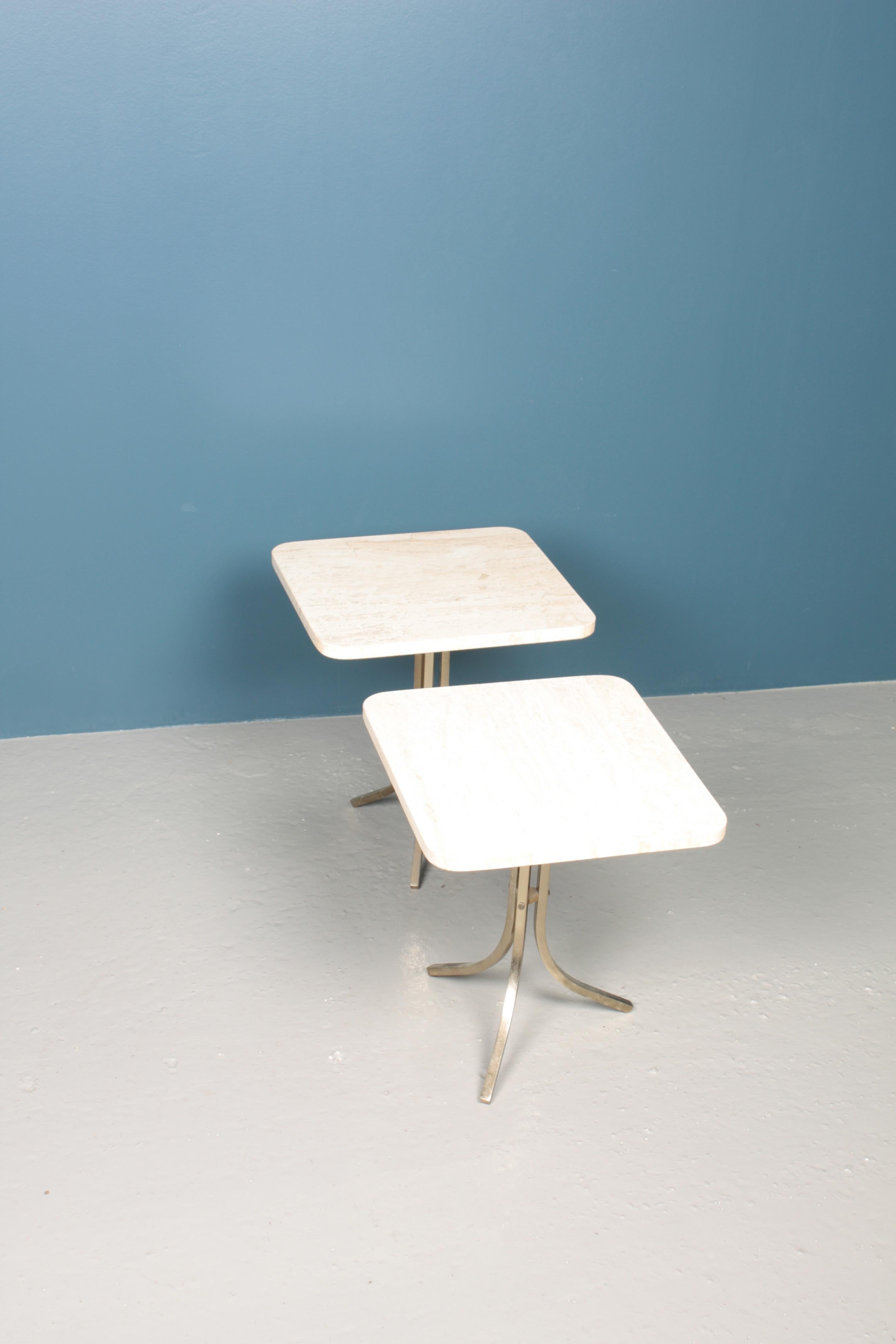 A pair of side tables with travertine top on a solid brass frame. Great original condition.