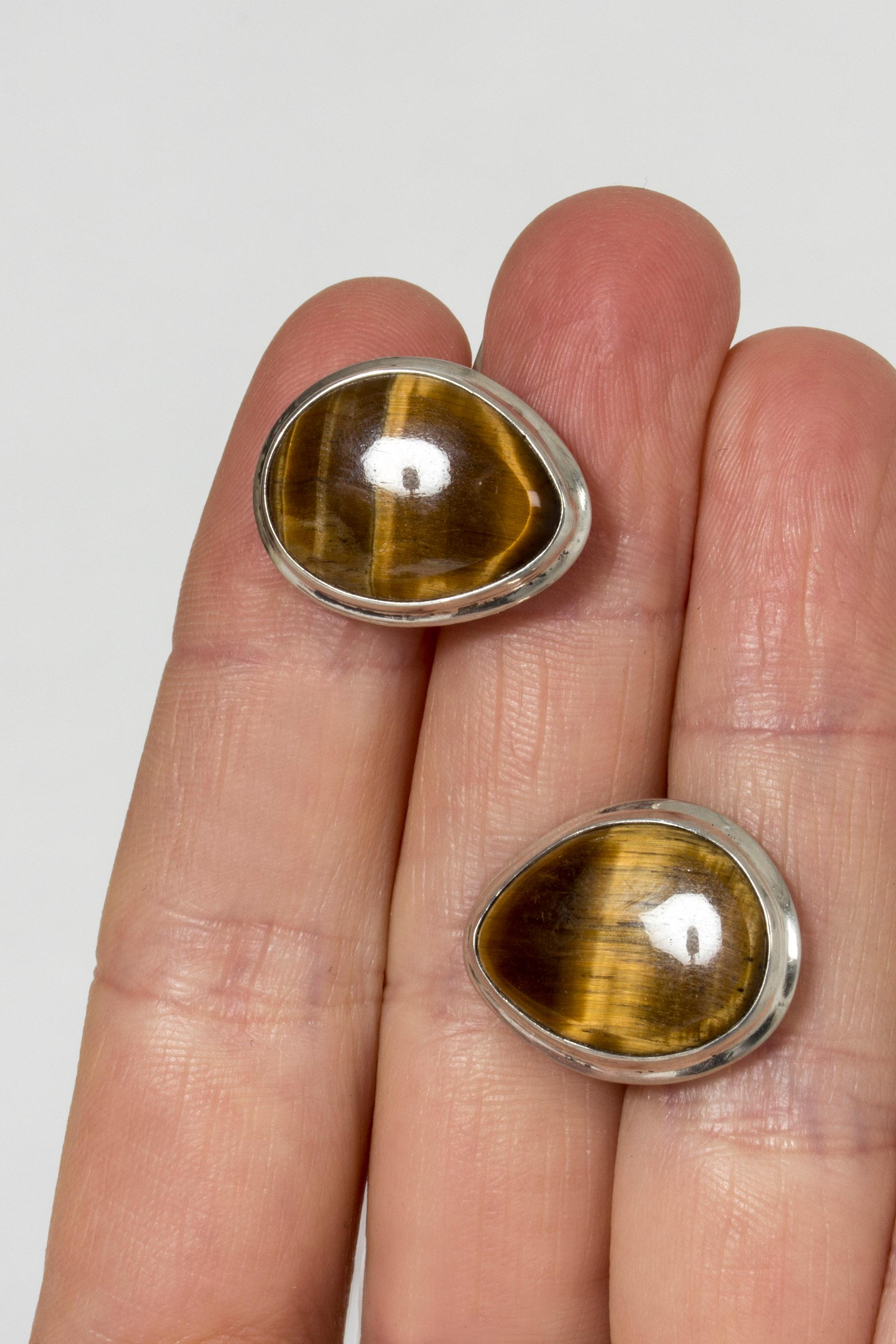 Pair of midcentury silver cufflinks set with drop-shaped tigereye stones. Nice size and lovely sheen.