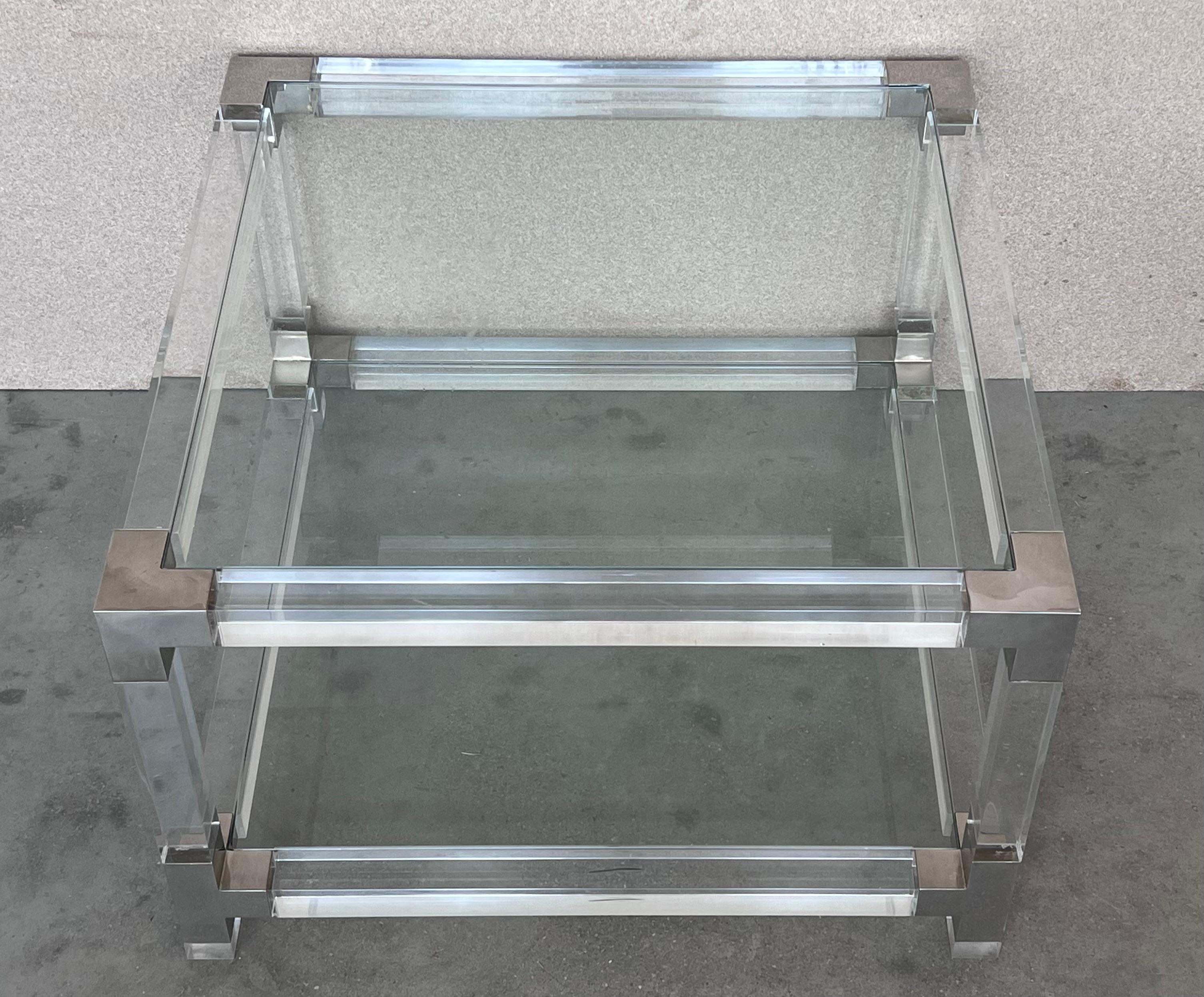 Pair of midcentury square lucite coffee tables with chromed metal details.

We have matching large square coffee table available : 39.37in.