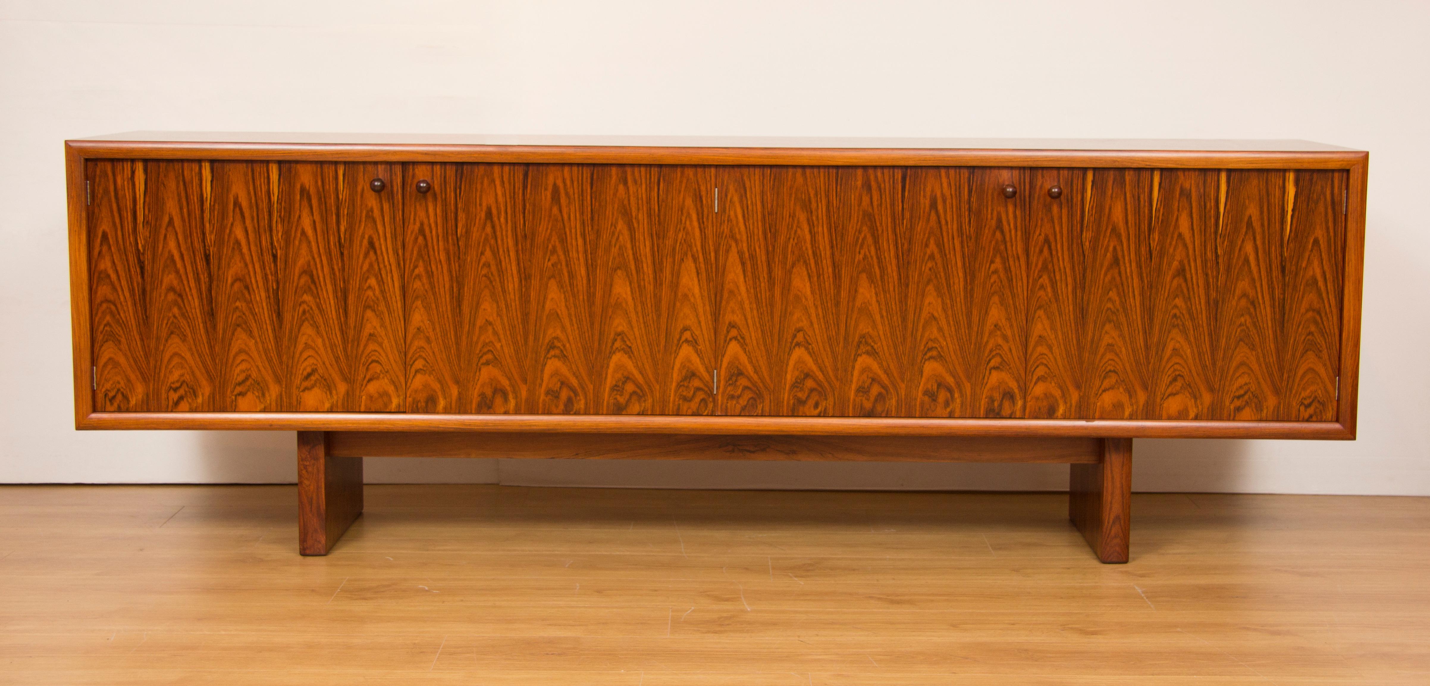 A pair of midcentury rosewood sideboards credenzas.
An extremely rare pair of sideboards design by Martin Hall and produced by Gordon Russell in the most stunning rosewood with contrasting Maple interior.
Model GR75
Measures: 71 cm H 213.5 cm W