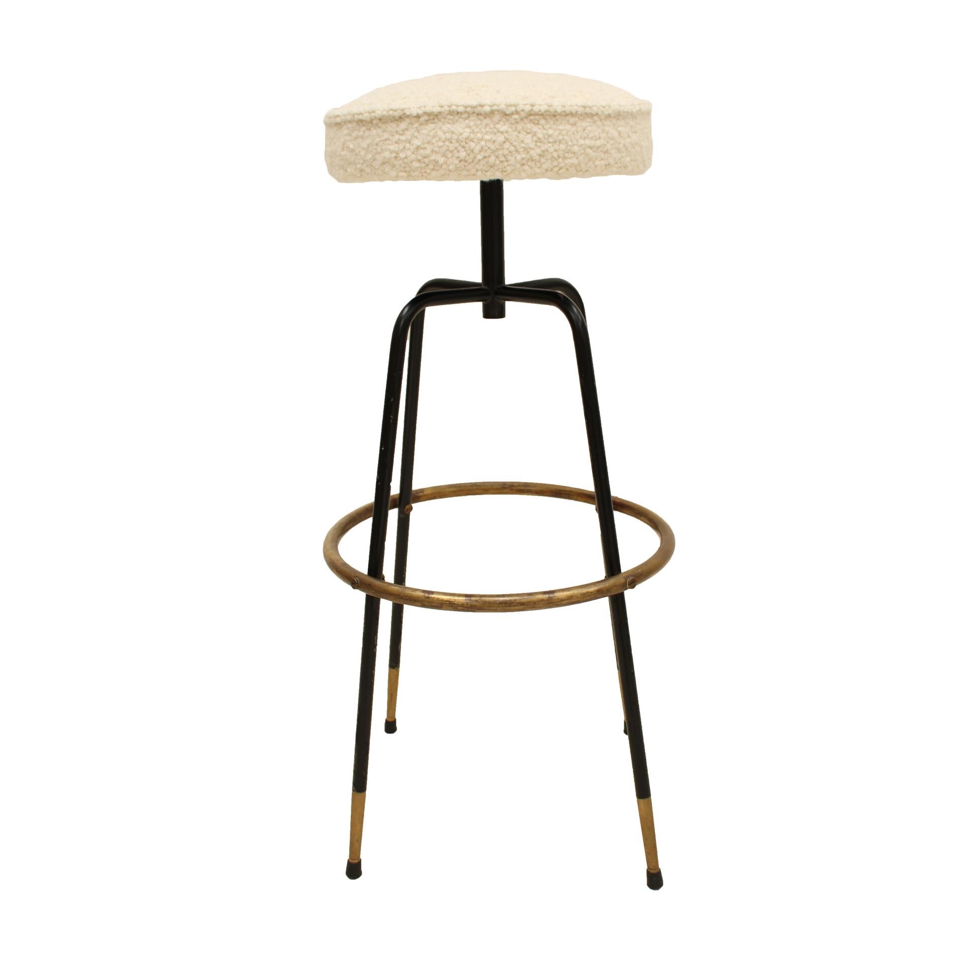 Pair of Italian stools from the 50's made with black lacquered metal structure and brass details. Upholstered in bouclé.