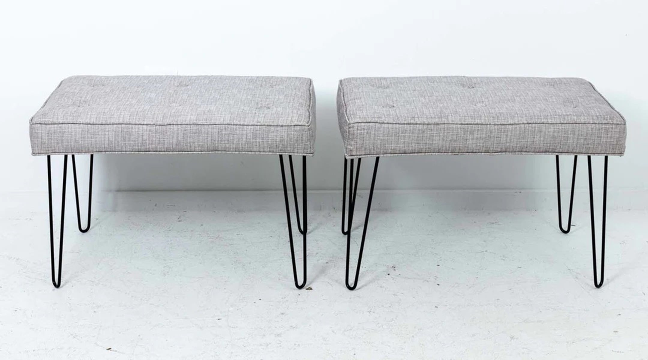 Circa 21st century pair of Mid-Century Modern style newly made upholstered benches with satin black hairpin shaped legs and new  upholstered seats with buttons and welting. Price is for the pair. Made in the United States. Good overall condition.