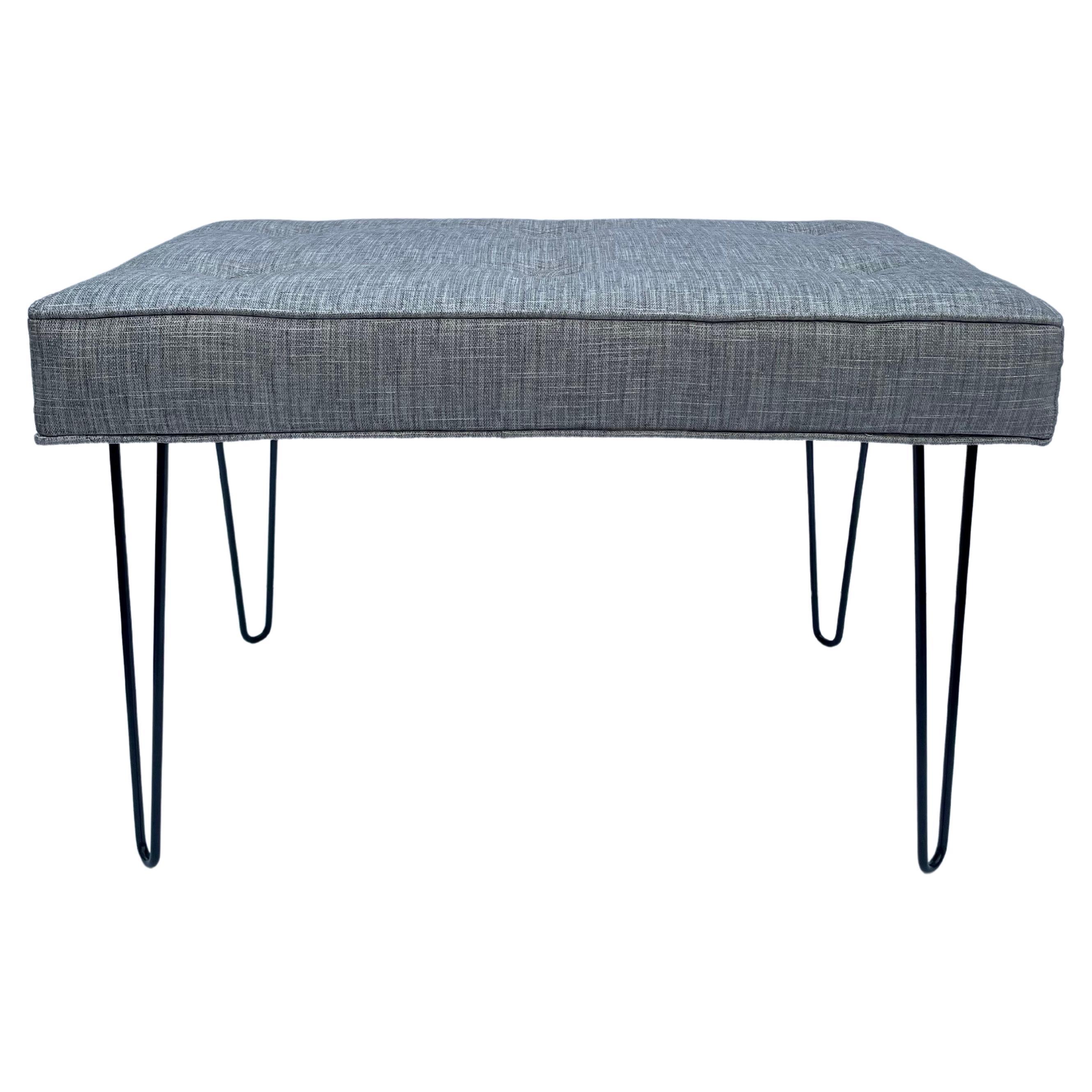 Circa 21st century pair of Mid-Century Modern style newly made upholstered benchs with satin black powder coated hairpin-shaped legs and new upholstered seats with six buttons each, welting top and bottom. 30