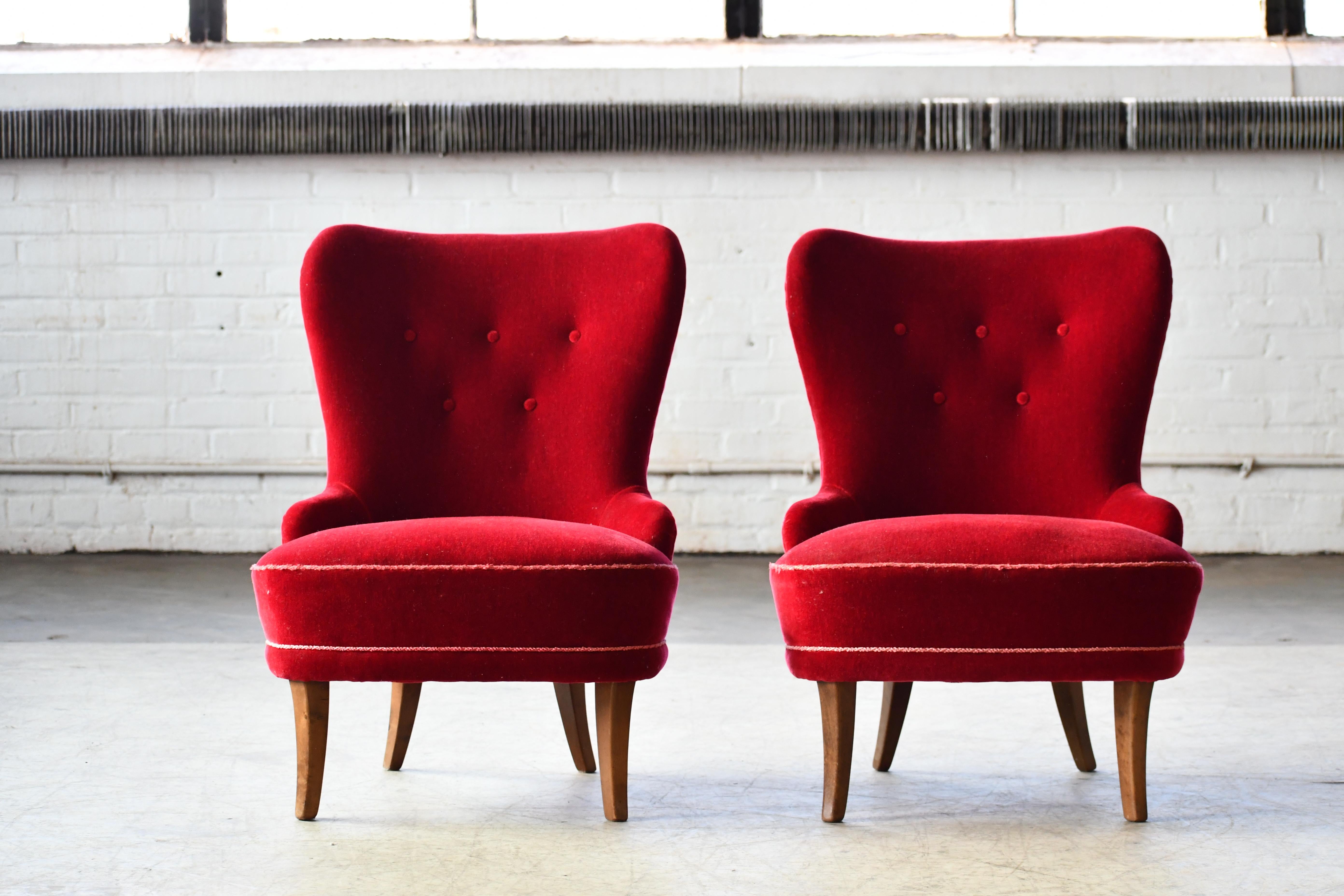 Very charming pair of slipper chairs in traditional midcentury Swedish style as also exemplified by Carl Malmsten. Red mohair velvet in very good condition raised on nice saber shaped legs in elm. Relatively small and convenient while still