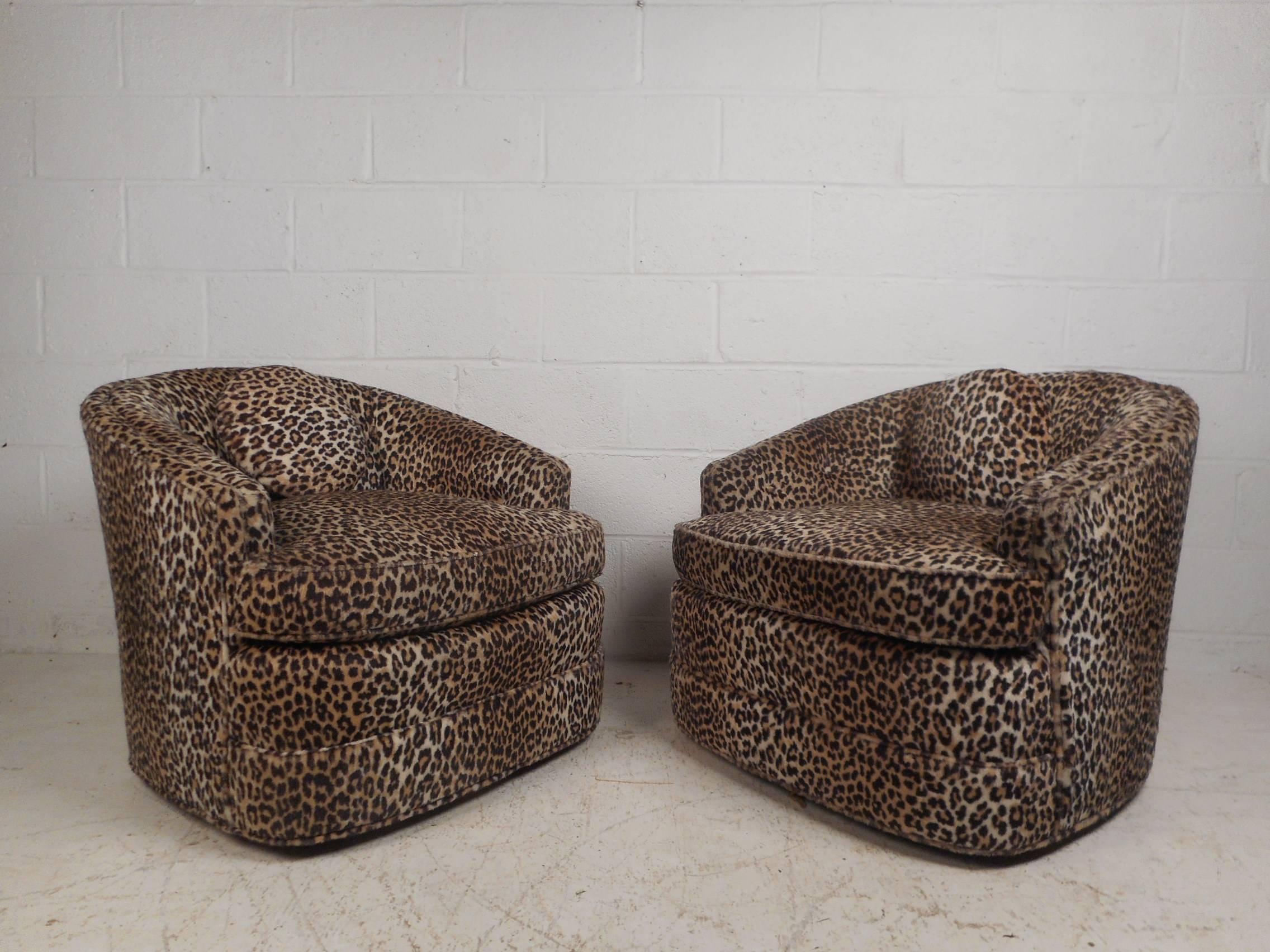 This stunning pair of vintage Henredon Shoonbeck lounge chairs feature extremely soft leopard upholstery and removable cushions. The low sitting swivel design with angled arm rests provides maximum comfort in any seating arrangement. This stylish