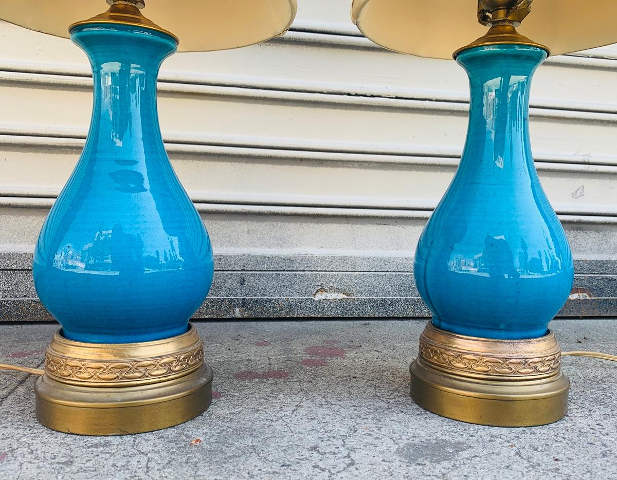 Vivid turquoise glazed ceramic lamps on brass bases, attb to Aldo Londi for Bitossi.The lamps are in very good original condition, they come with the original shade.

Measurements:
20.50 inches high to top of finial by 4.50 inches base diameter