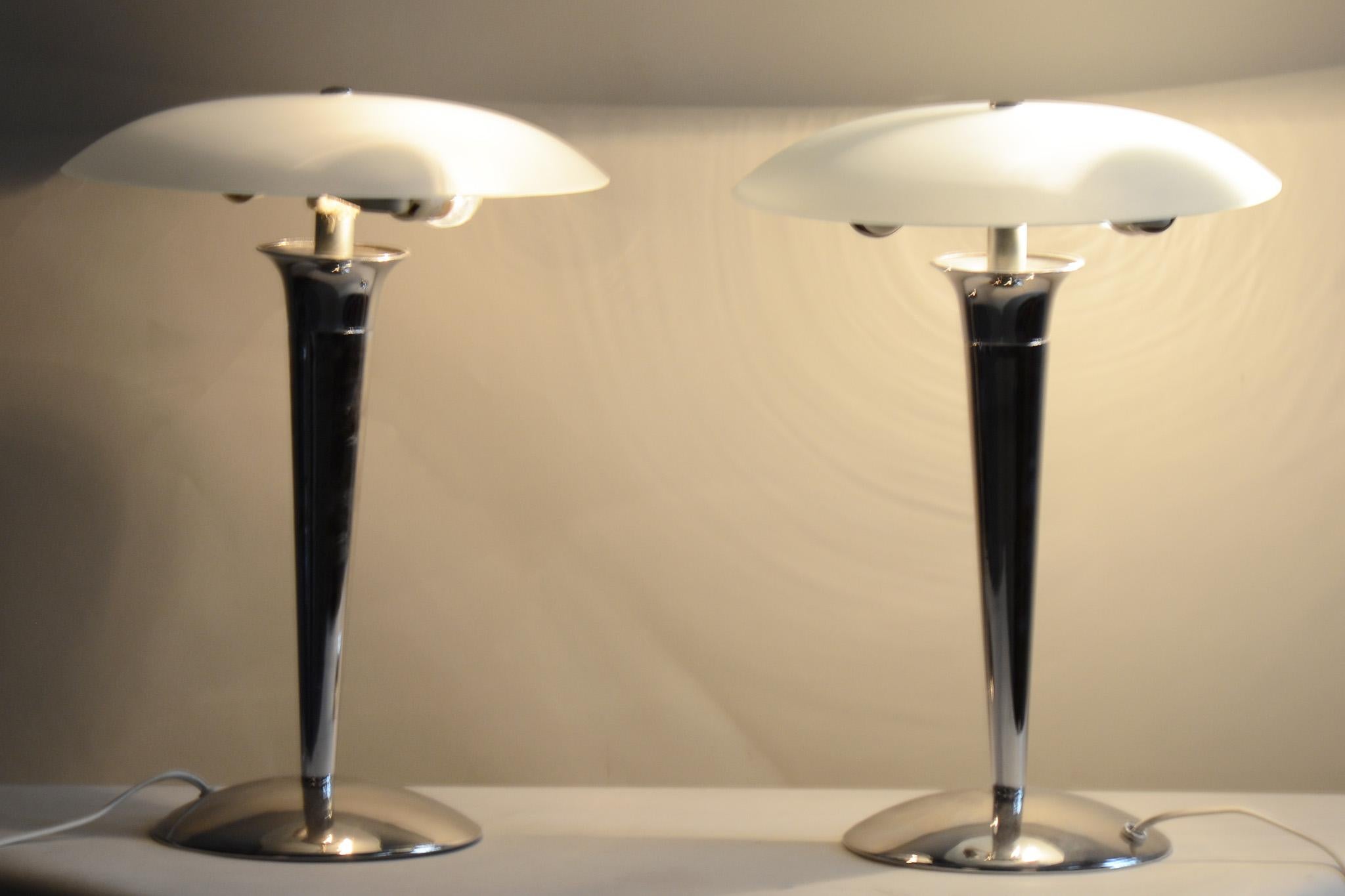 Pair of midcentury table lamps.

Period: 1950-1959
Source: Germany
Material: Chrome-Plated Steel, Milk Glass

It has been fully restored by our professional refurbishing team in Czechia according to the original process. The chrome parts have