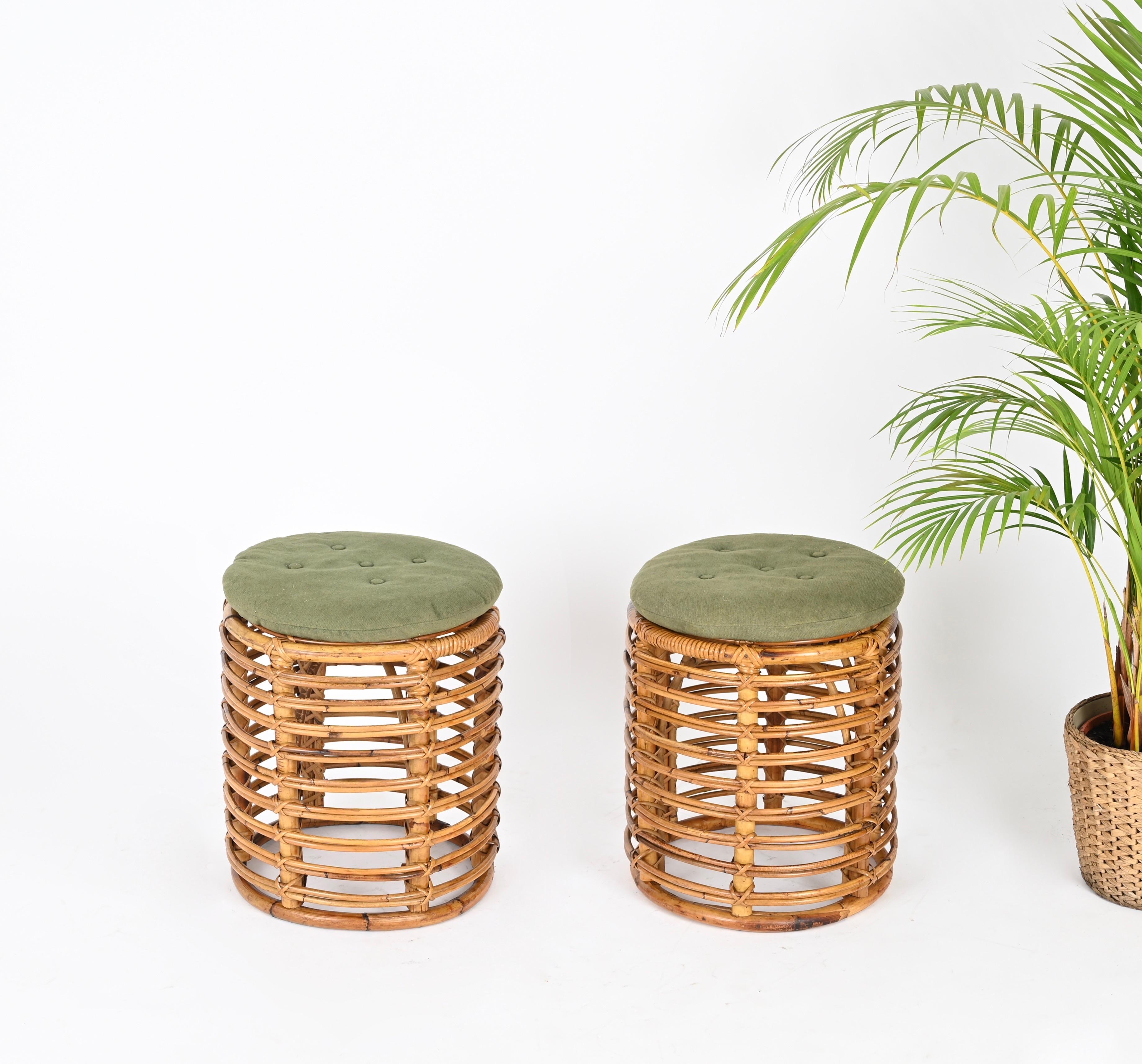 Stunning pair of  French Riviera poufs in curved bamboo, rattan and hand-woven wicker. These fantastic and rare poufs were designed by Tito Agnoli and made in Italy during the 1960s. The poufs are completed by it's original green cushions.

The