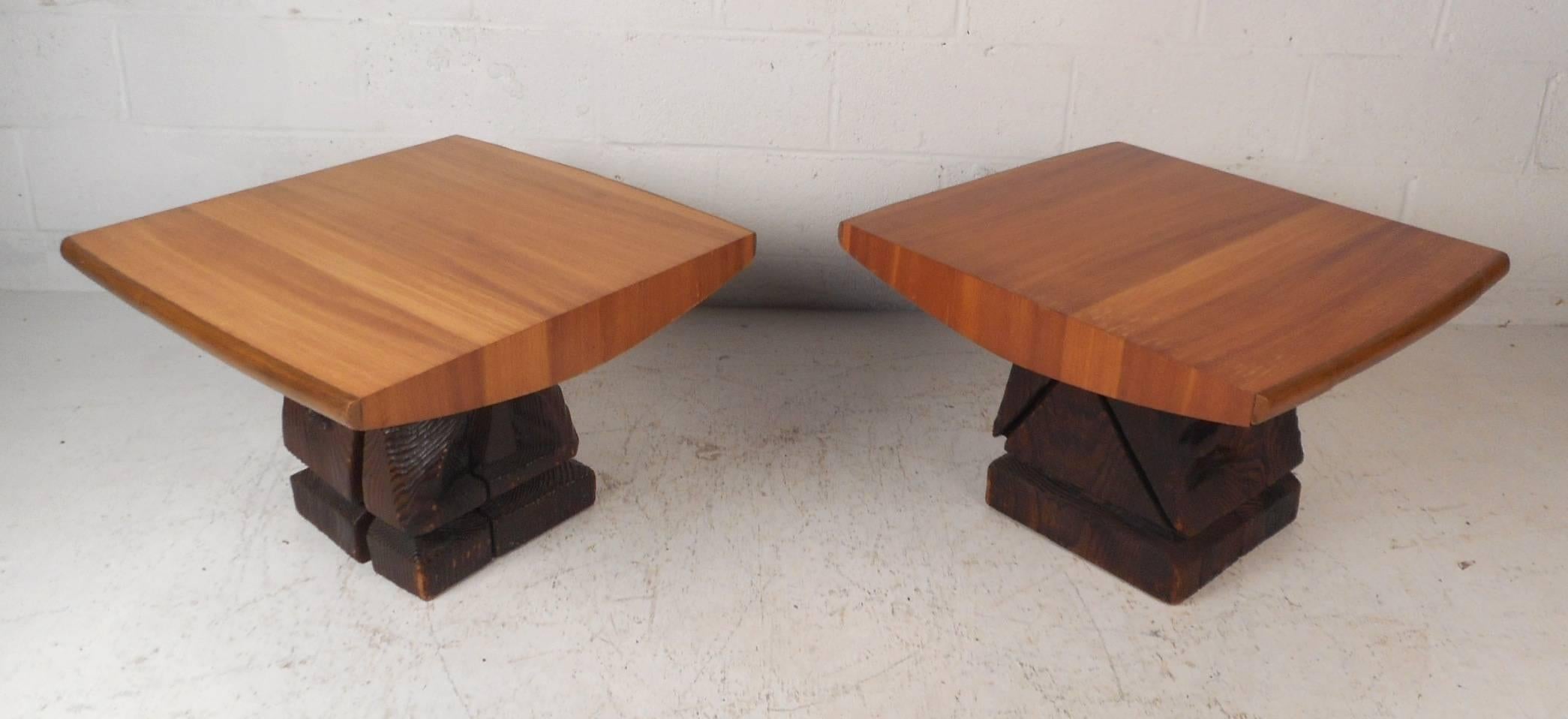 This wonderful pair of vintage modern end tables by Witco feature carved dark wood bases with a sculpted blonde wood top. An extremely sturdy pair with intricate detail displaying true quality craftsmanship. This unusual pair is sure to make a