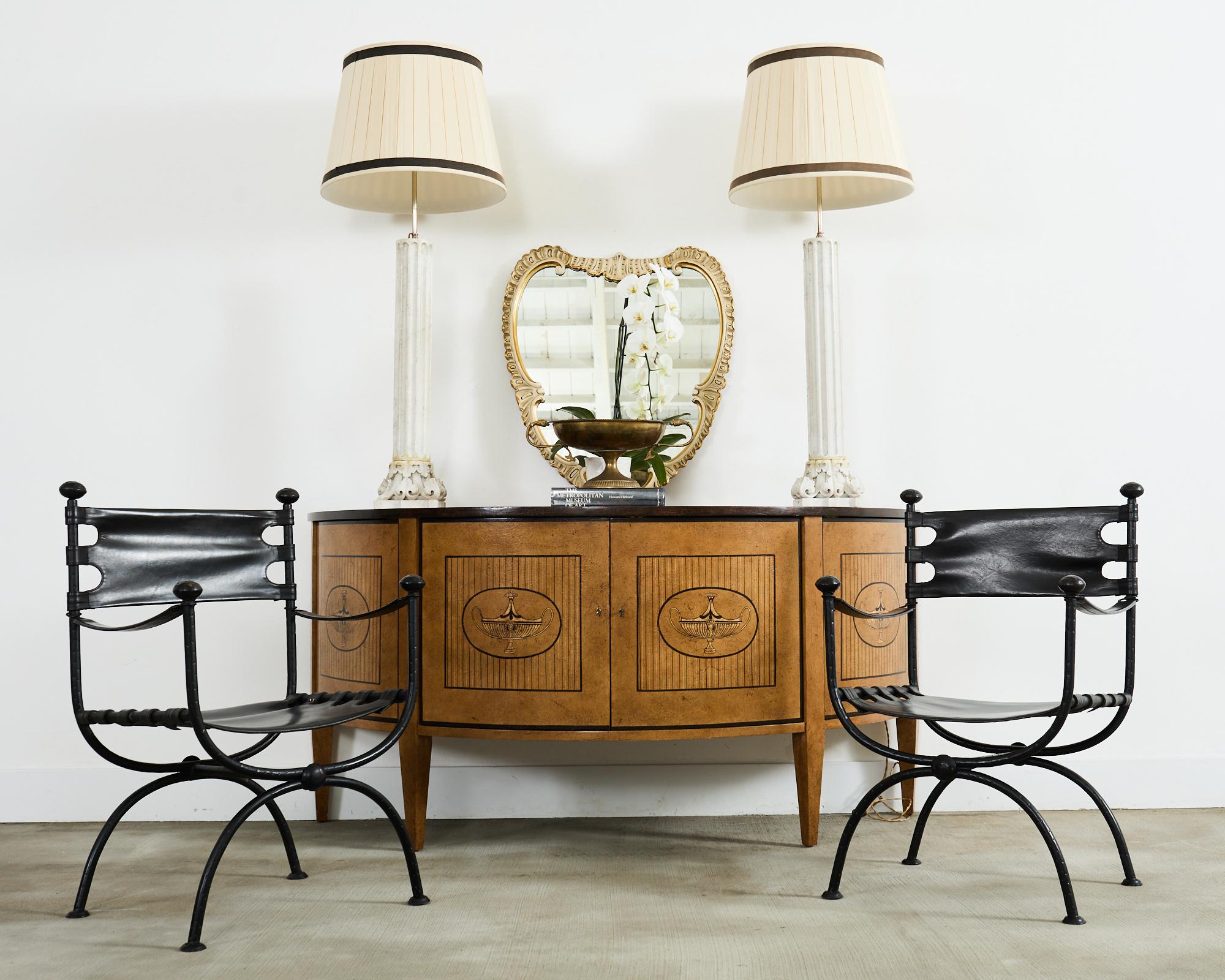 Gorgeous pair of mid-century modern period cartouche wall mirrors crafted in Italy. The carved frames are decorated in the Venetian style with rococo revival C scrolls and shell rocaille borders. The frames are lacquered with an oyster color having