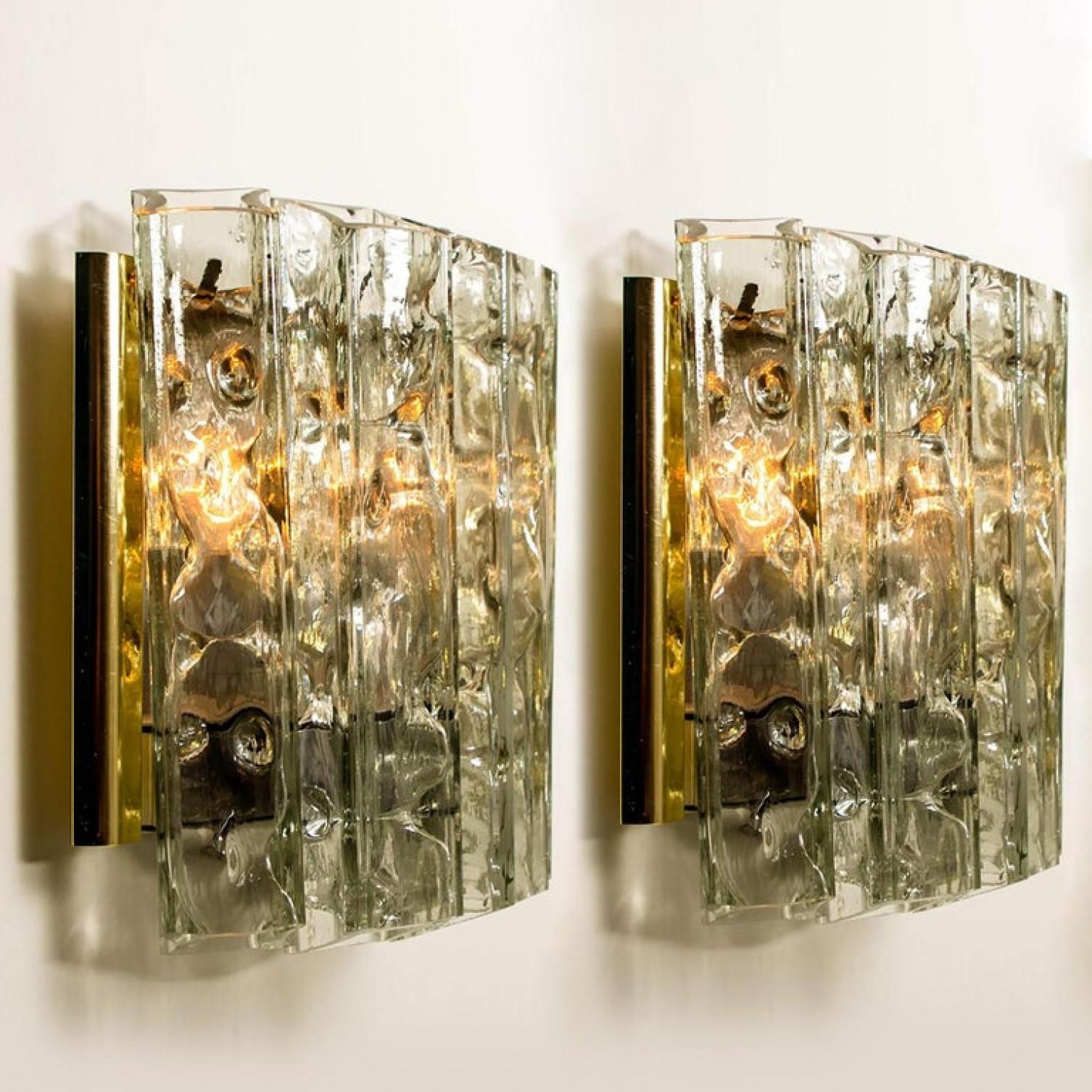 Wonderful pair of high-end wall lamps. Manufactured in the 1960s. The stylish elegance of this lamp suits many environments, from 20th century to Hollywood Regency, from Danish modern to Space Age and contemporary interior.

Metal structure with