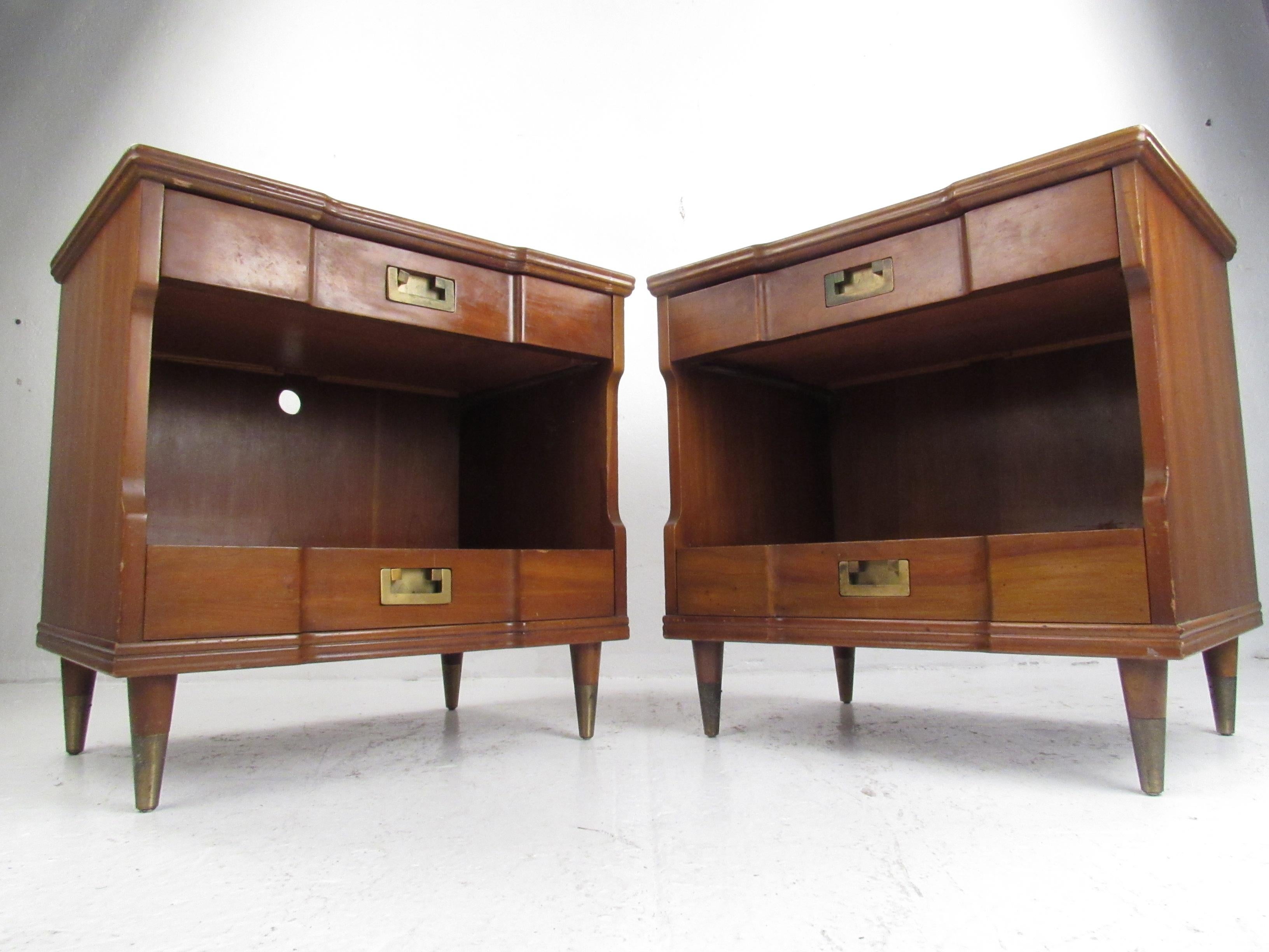 Vintage pair of two-drawer walnut nightstands with brass pulls and sabots, manufactured by Widdicomb Furniture, Grand Rapids, Michigan.
Please confirm item location (NY or NJ) with dealer.