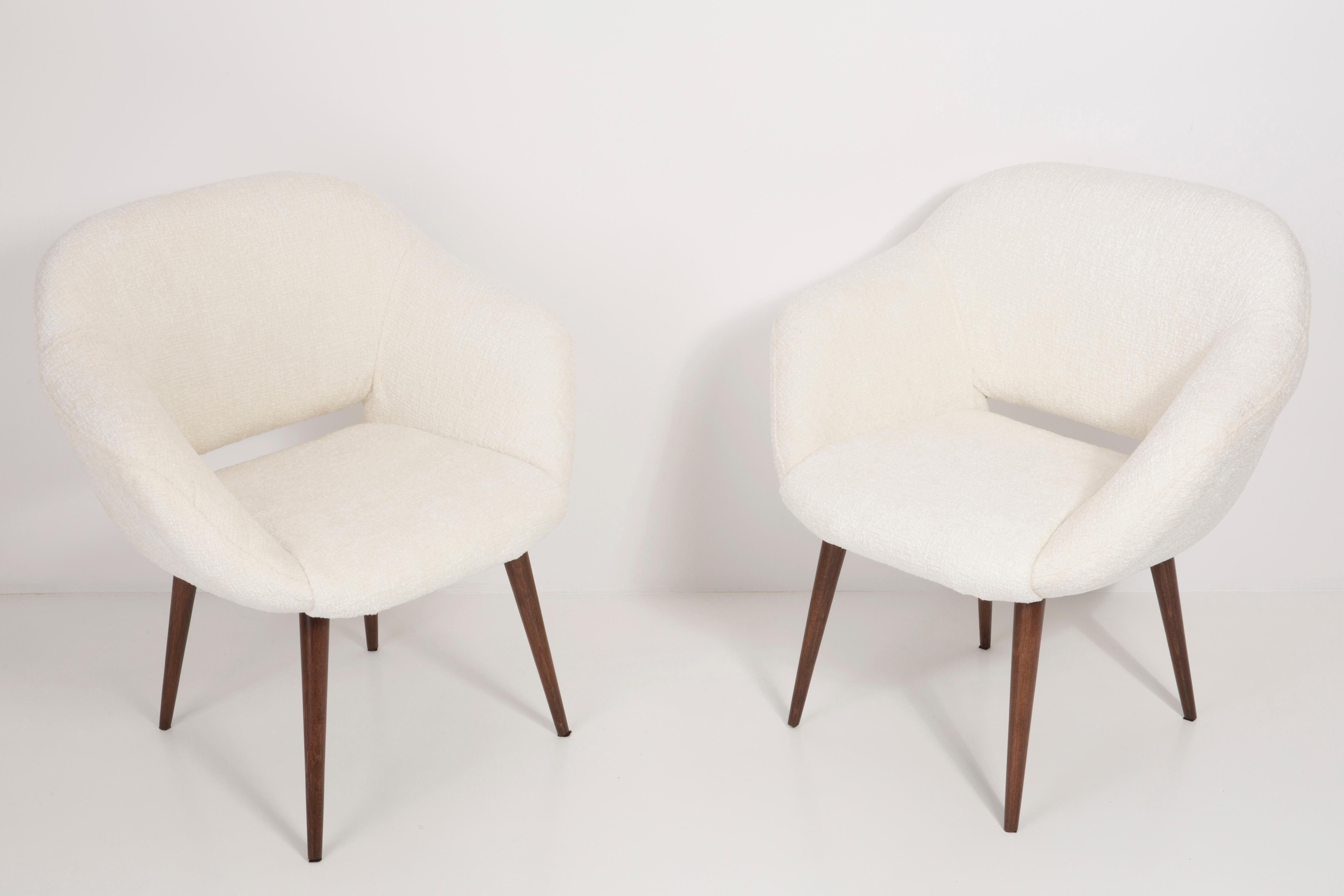 German armchairs produced in the 1960s in Berlin. The armchairs are after a thorough renovation of upholstery and carpentry. The wooden frame is thoroughly cleaned and covered with a semi-matte varnish in the color of a nut. The upholstery is made