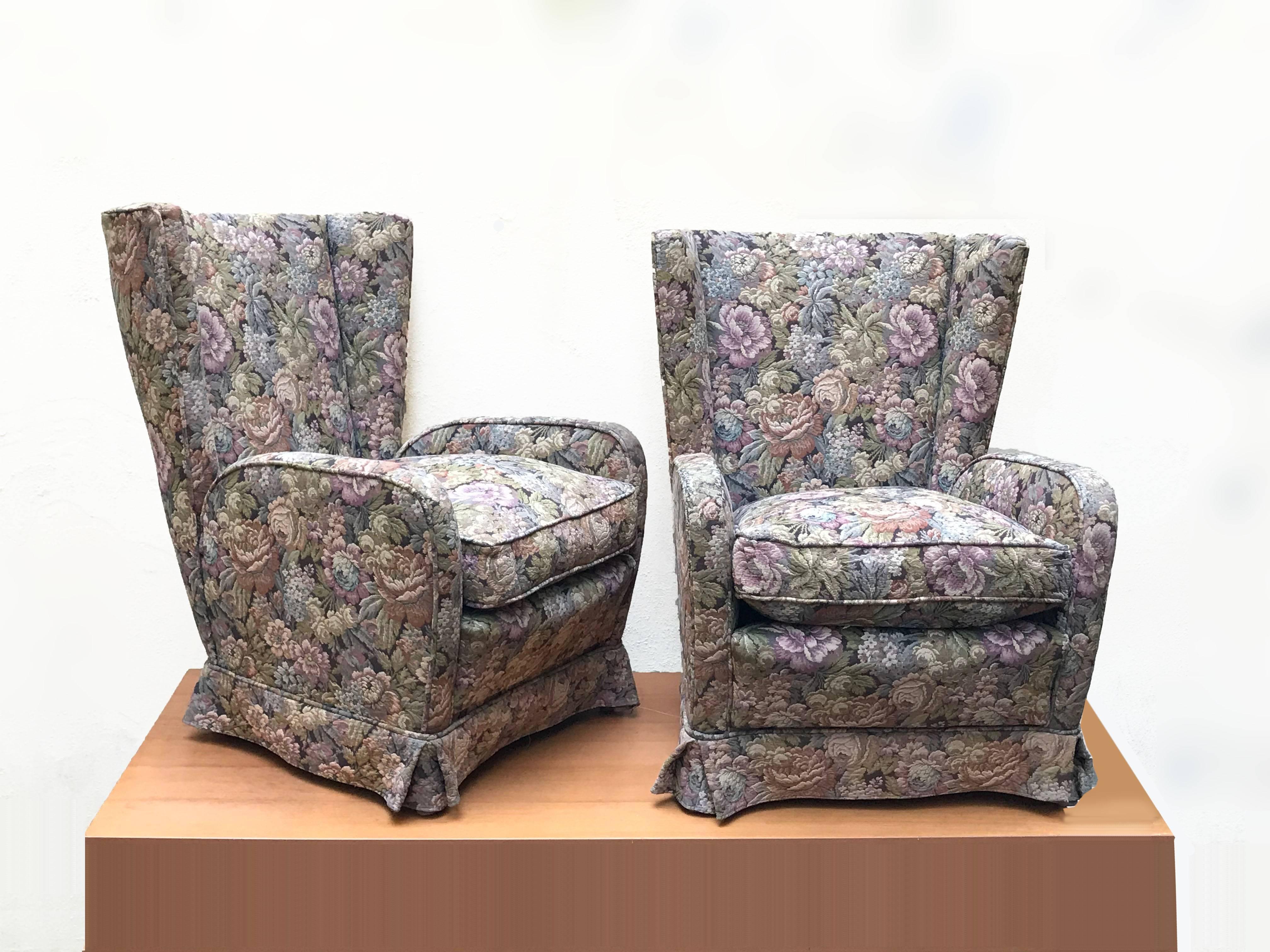 These wonderful and iconic armchairs were produced in Italy during the 1950s.

The armchairs have the original floral wool upholstery of the wooden legs.

The harmony of the lines and the elegant and midcentury color mix is breathtaking, these