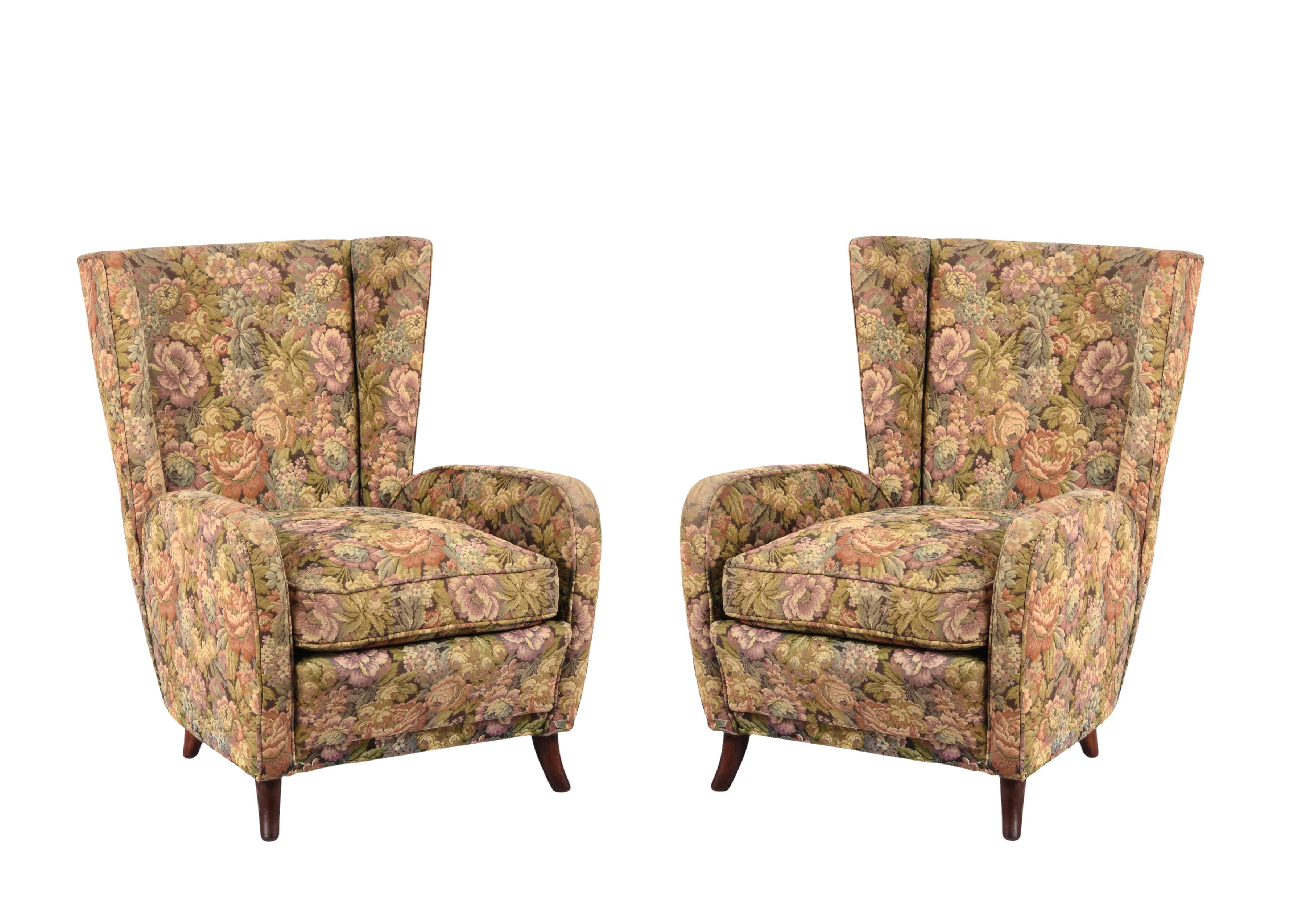 These wonderful and iconic armchairs were produced in Italy during the 1950s. The Armchairs have the original floral wool upholstery.

The harmony of the lines and the elegant and midcentury color mix is breathtaking, these items are perfect for a