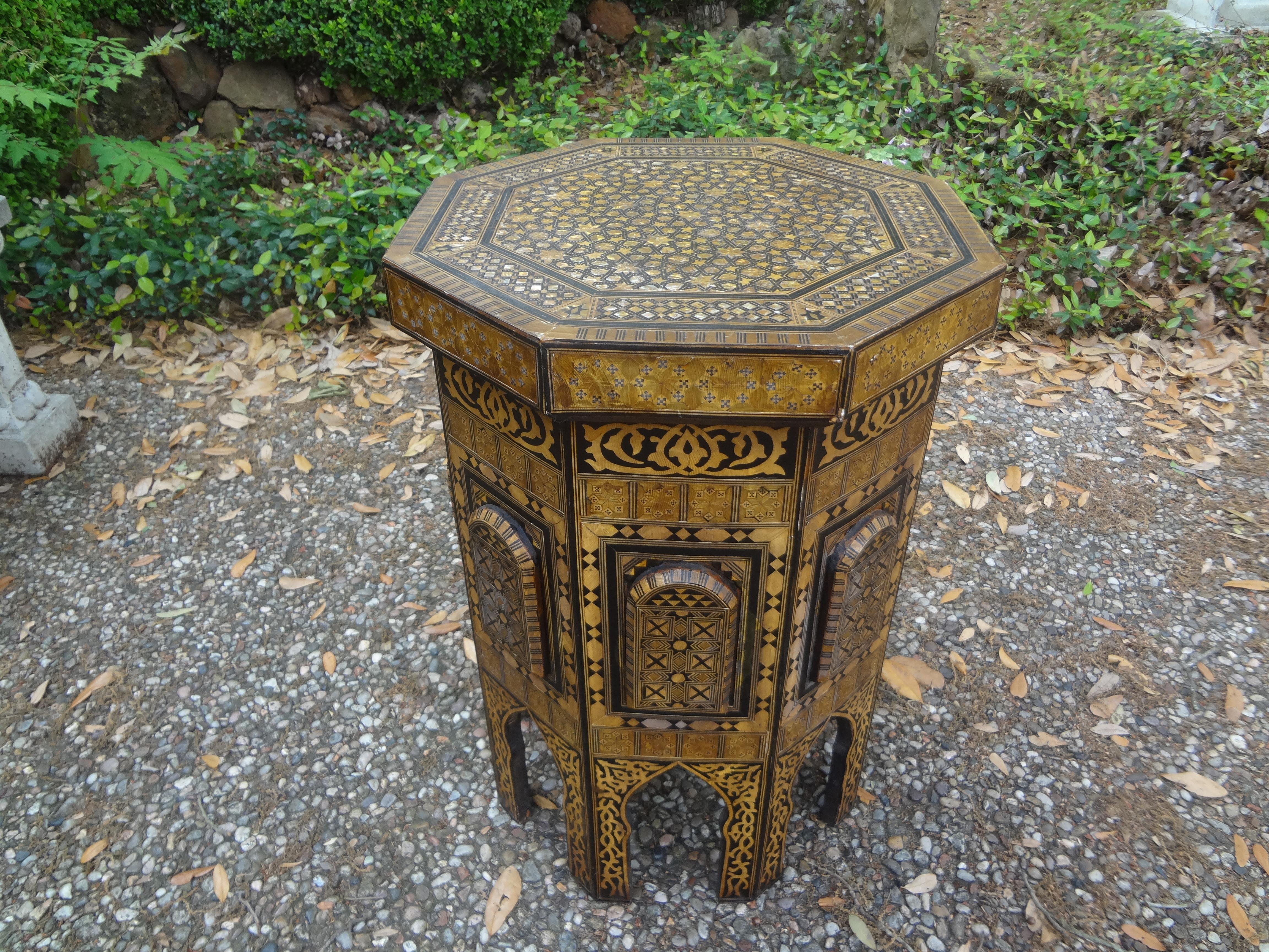 Pair Of Middle Eastern Moorish style tables. This pair of tables, side tables or drink tables are octagonal in shape and are inlaid with a variety of wood and mother of pearl. Our versatile Arabesque style tables are either Moroccan or Syrian in