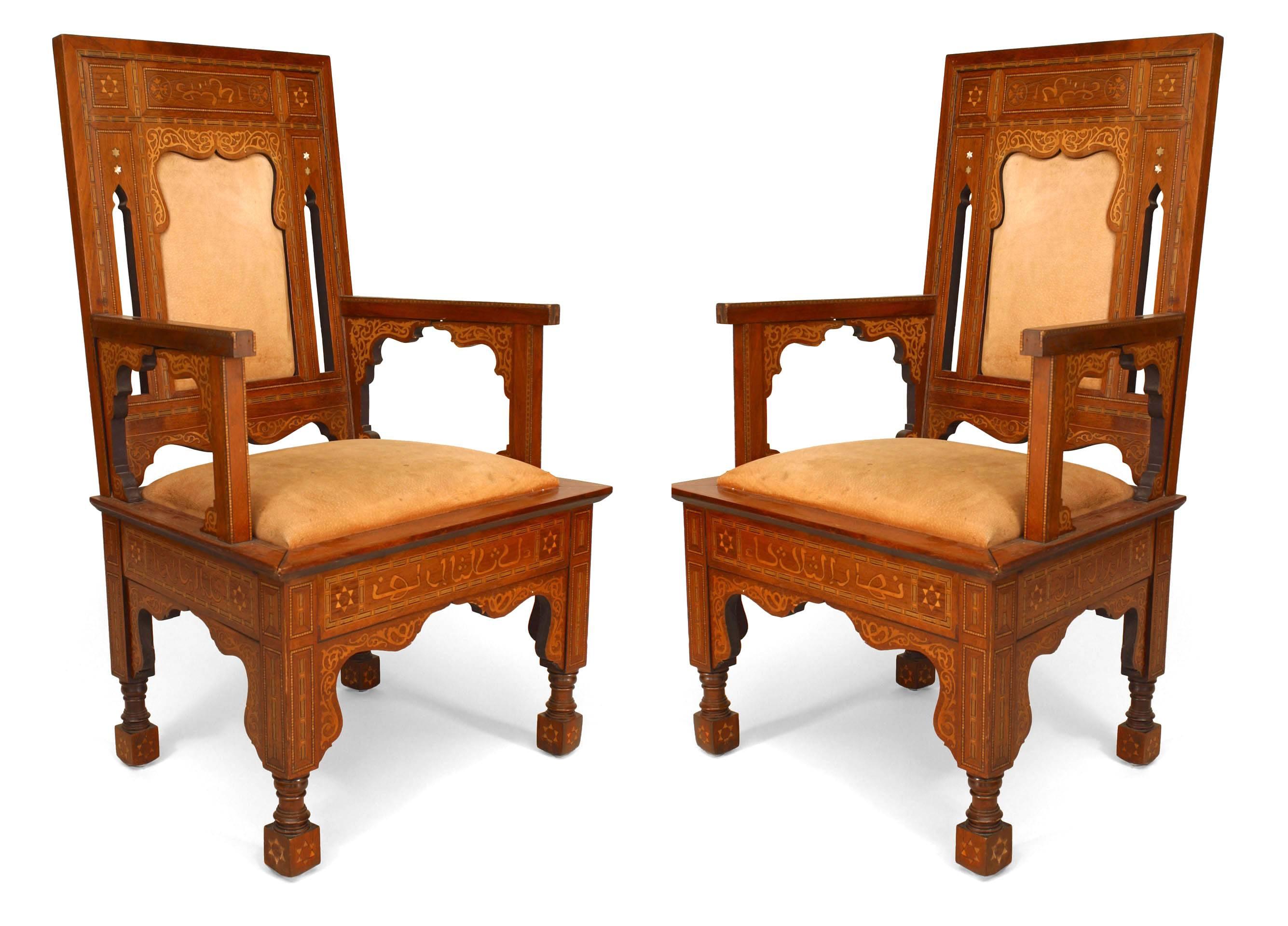 Pair of Middle Eastern Moorish/Syrian walnut Armchairs (19/20th Cent) with inlaid decoration and Arab script with an arch design cut out back and brown suede seat.

