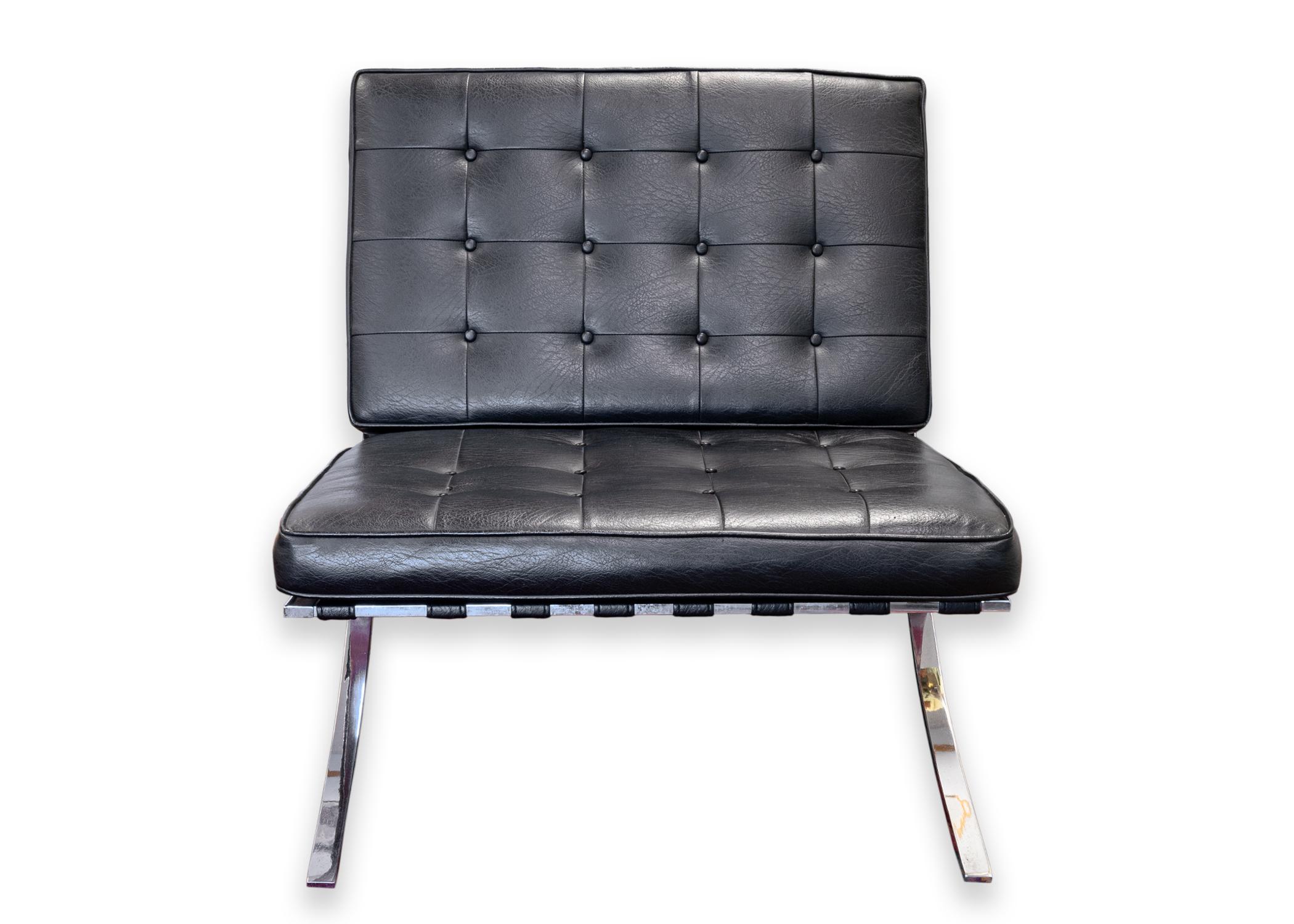A pair of Mies van der Rohe Barcelona style accent lounge chairs. A super high quality reproduction pair of Barcelona chairs. These chairs feature black tufted leather seats and backs, and a full polished metal frame construction. Both the seat and