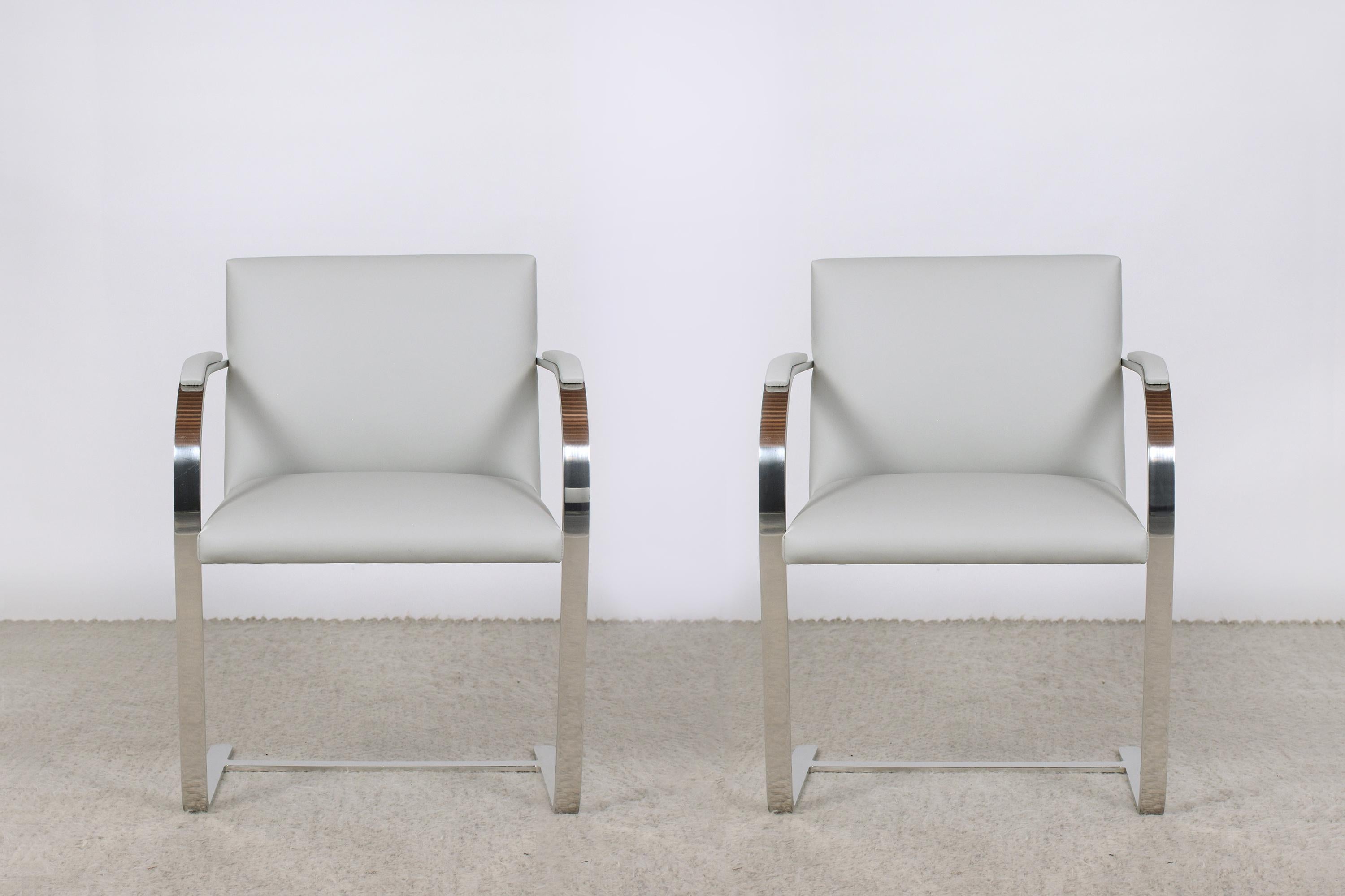 An extraordinary set of two Mies Van Der Rohe Brno Armchairs by Knoll is in great condition and has been newly upholstered by our team of expert craftsmen. The chairs have a sturdy steel frame that has been polished/buffed and is newly upholstered