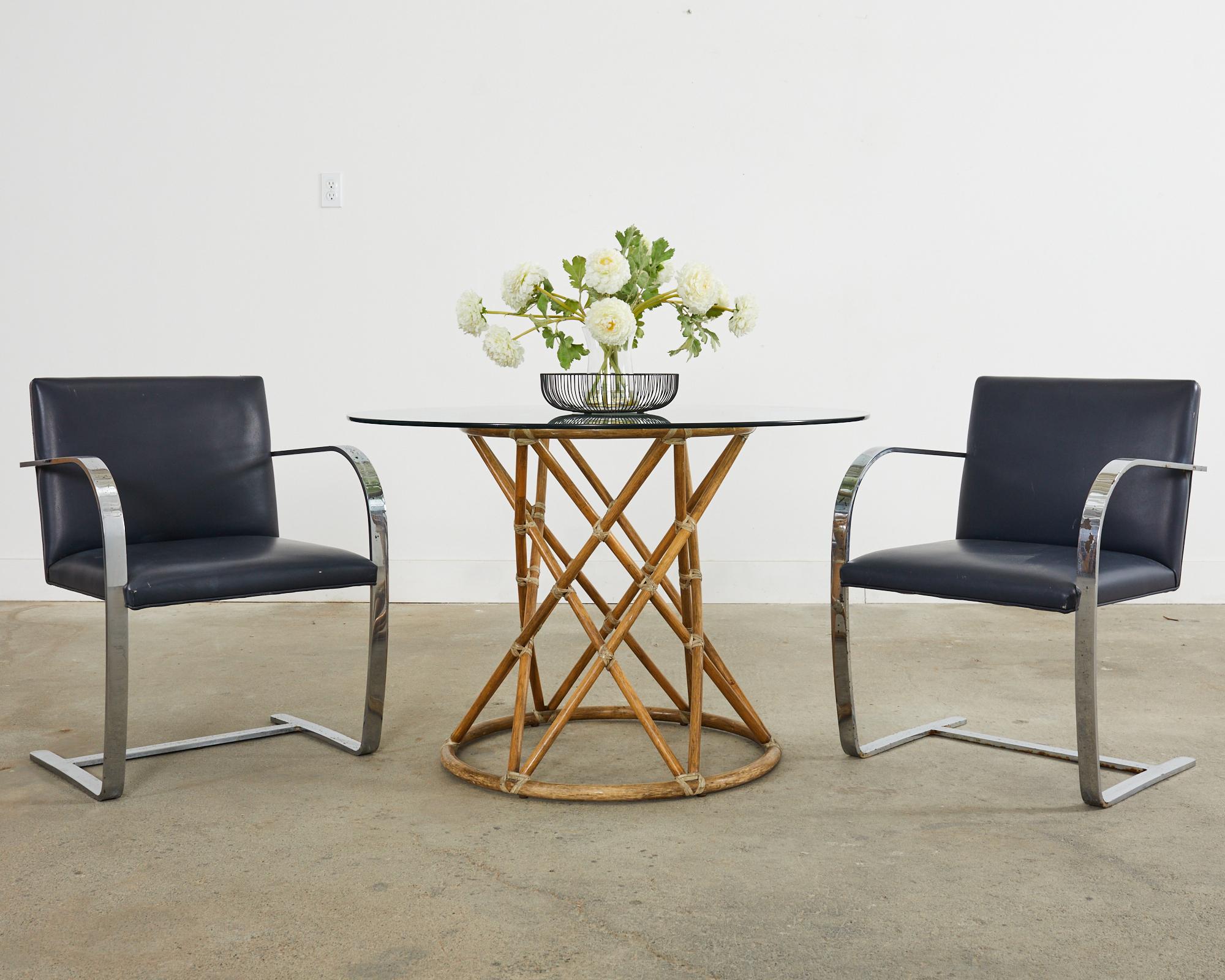 Mid-Century Modern pair of Mies van der Rohe for Knoll brno armchairs. The chairs feature a steel flat bar design with a chrome finish. The frames have navy blue leather seat covers. Knoll order tags on the bottoms of the seats. The chrome finish is