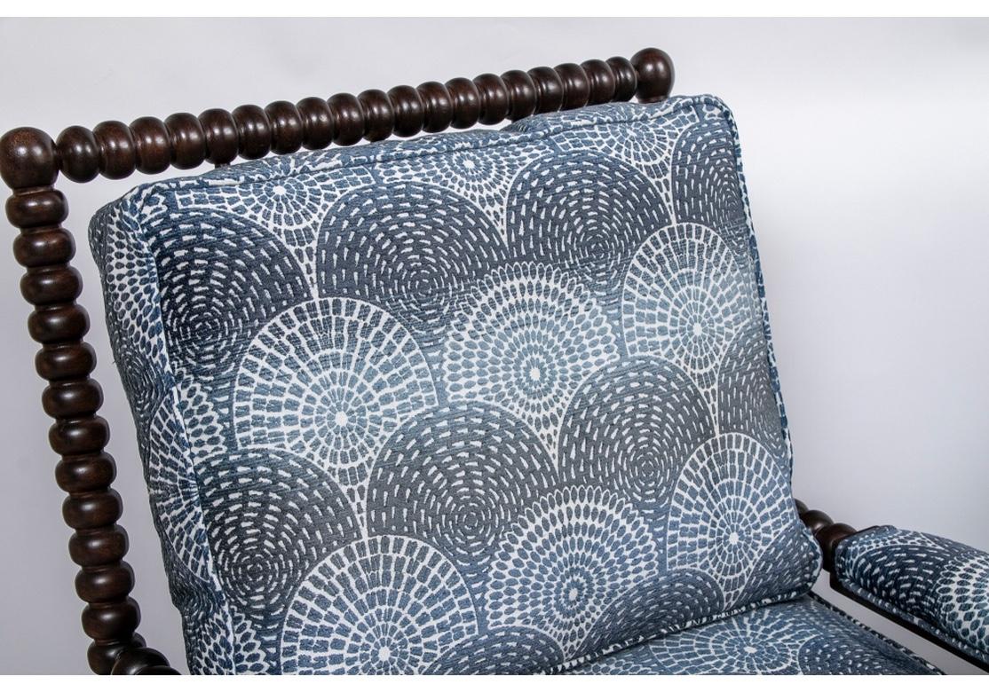 Deep stained bobbin carved frames along the square backs front and back, the arms and front legs. With slanted backs, bobbin form front legs and square splayed back legs. Newly upholstered in a sophisticated cut velvet type fabric in a blue on white