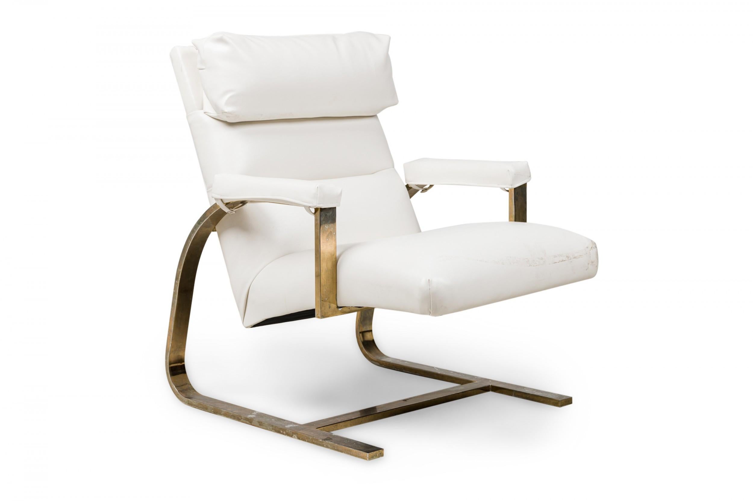 PAIR of midcentury American brass flat bar, cantilevered armchairs in a relaxed back-tilted position, with padded head and armrests, upholstered in white leather. (Milo Baughman) (PRICED AS PAIR).