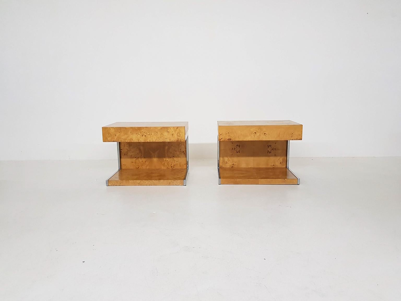 Pair of nice burl wood night stands with chromed details. We think it is a design by Milo Baughman for Thayer Coggin. These tables were received from the Hilton hotel where they were used in a luxury suite. The stands are stamped with the number