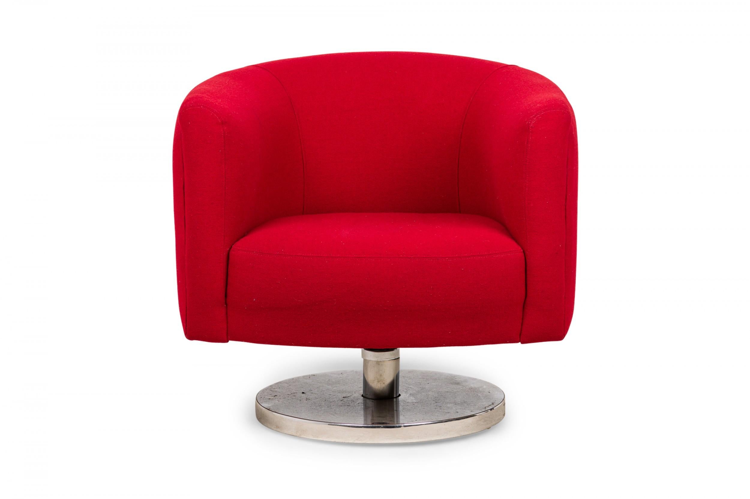 PAIR of American Mid-Century tub form swiveling lounge / armchairs upholstered in bright red fabric and resting on circular chrome swivel bases. (MILO BAUGHMAN)(PRICED AS PAIR)