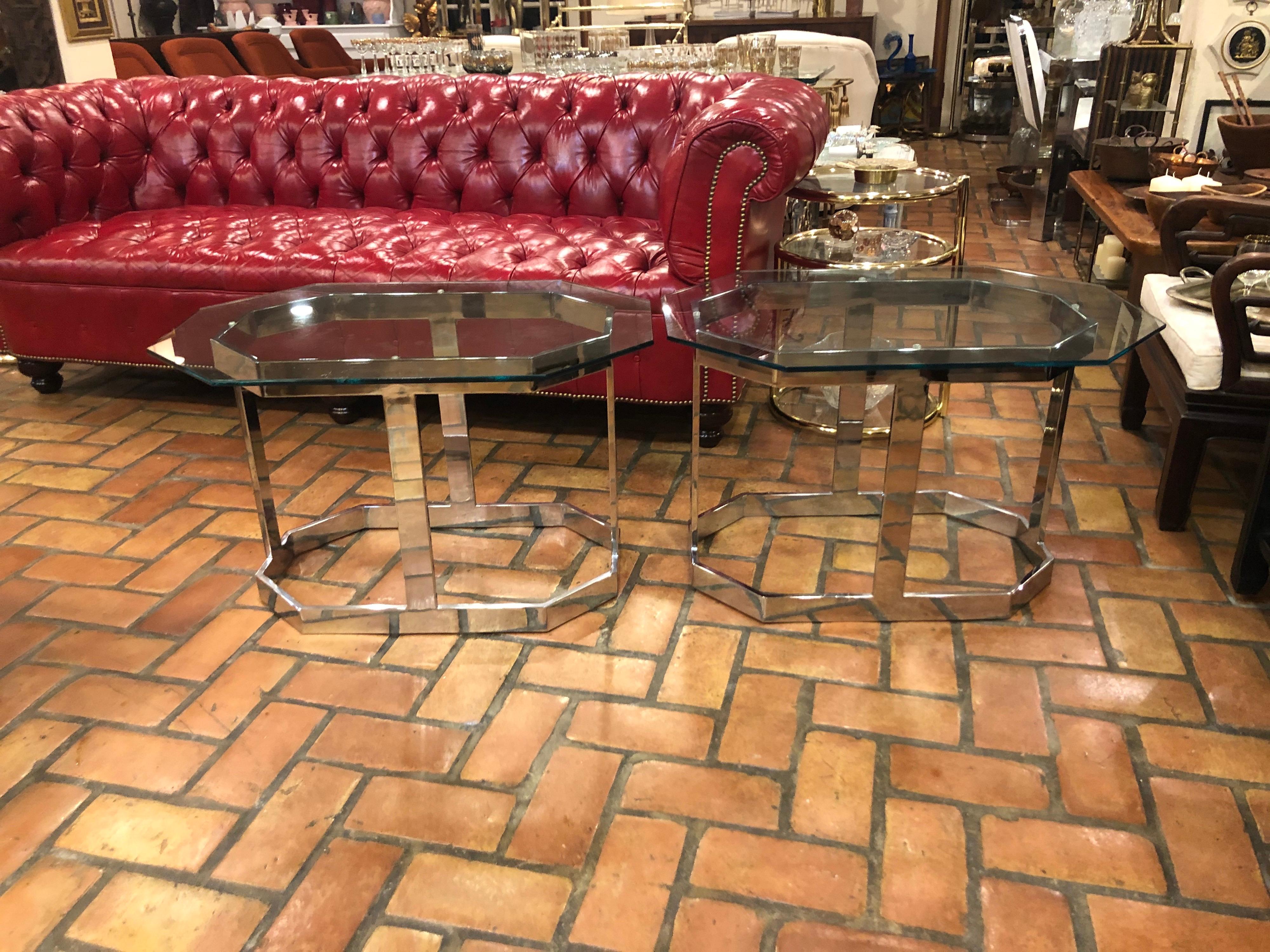 Pair of Mid Century chrome and glass tables. These tables are chrome not brass. Modern geometric octagonal design. Flat bar chrome and clear glass removable tops make up this duo. Elegant and sophisticated for that clean look. Use as end tables or