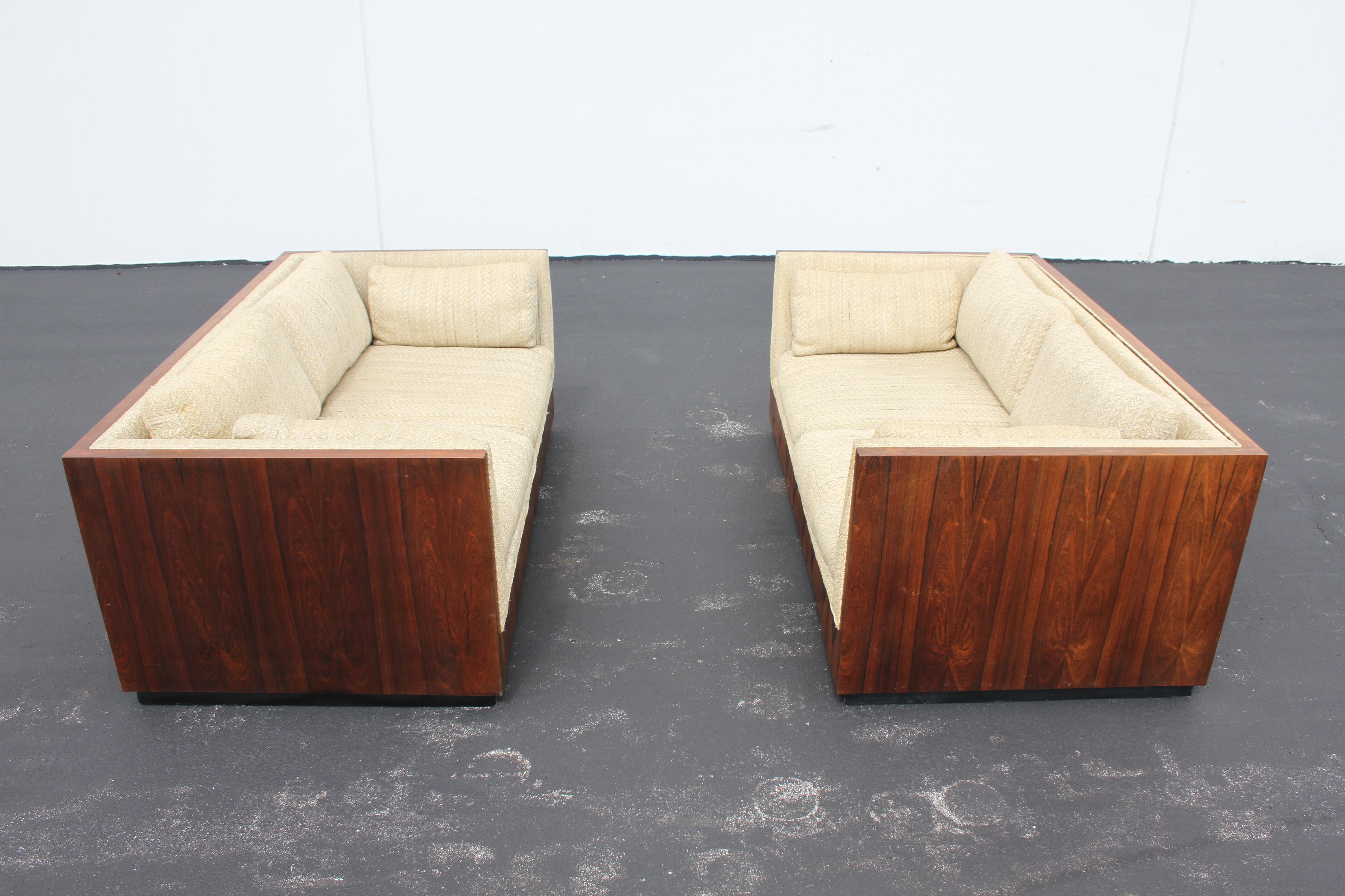 Pair of Milo Baughman for Thayer-Coggin model 1976 cubed formed settees with rosewood veneer on black floating base. Shown in all original condition with sun fading to finish, (Price includes refinishing of rosewood), work to be done prior to