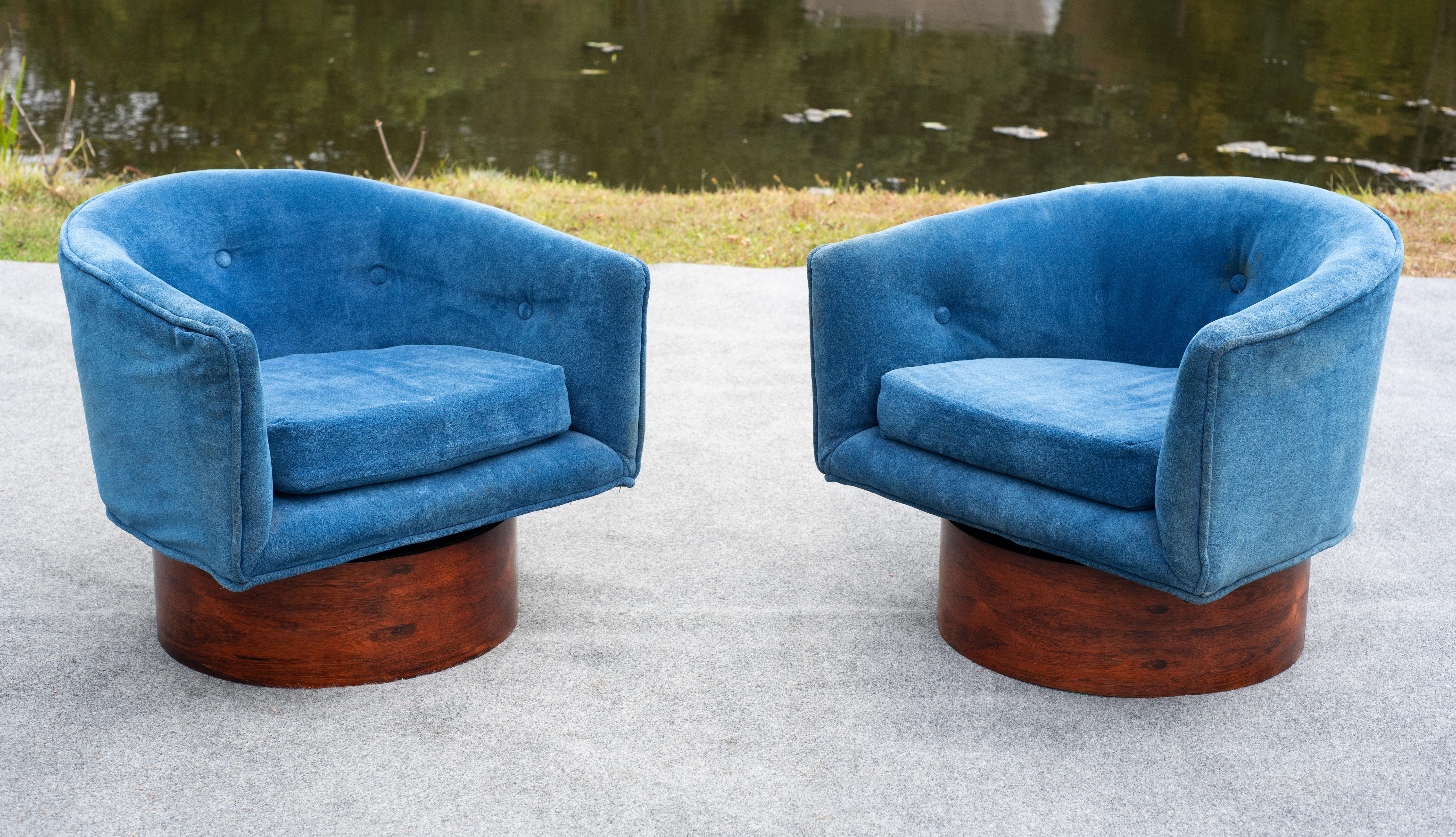 Superb and rare swivel lounge chairs designed by Milo Baughman and prodced by Thayer Coggin. Original cool blue upholstry on dramatic grain rosewood bases. Well-crafted and wonderfully designed, this sophisticated pair of chairs is an instant MCM