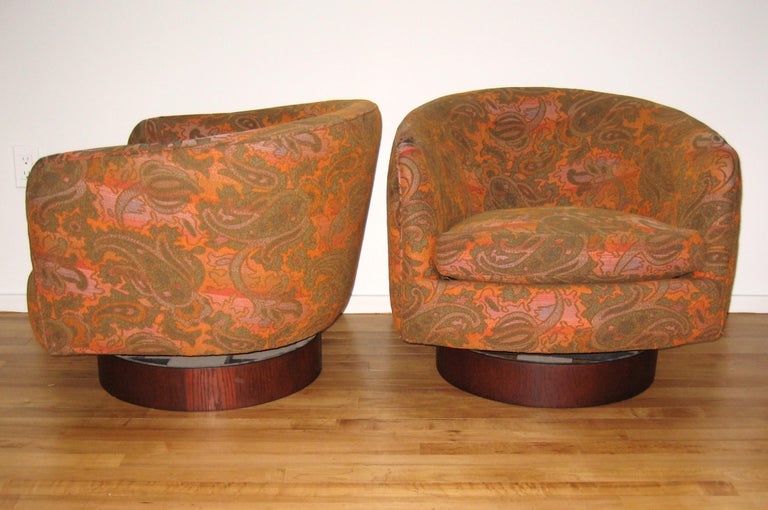 Pair of Milo Baughman for Thayer Coggin swivel and tilt lounge chairs. Great floral vintage fabric on these.
   