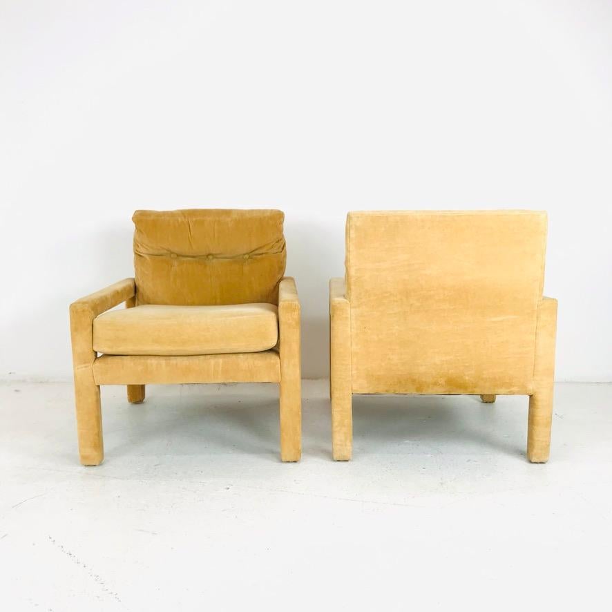 Iconic pair of Parsons style lounge chairs by Milo Baughman. Sturdy and solid, some minor cosmetic wear but in good vintage condition. 

