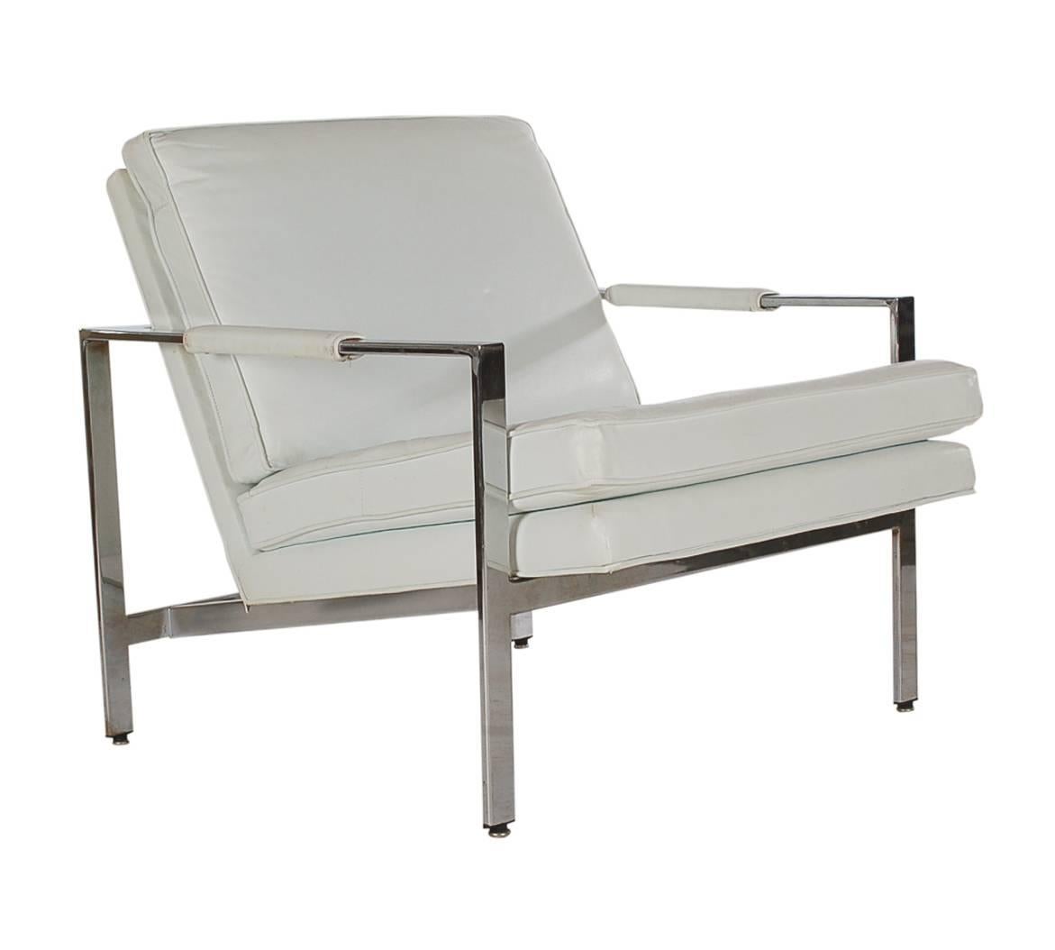 A stunning matching pair of flat bar lounge chairs designed by Milo Baughman and produced by Thayer Coggin. These feature chrome flat bar construction and white Naugahyde cushions. Price includes the pair as shown.